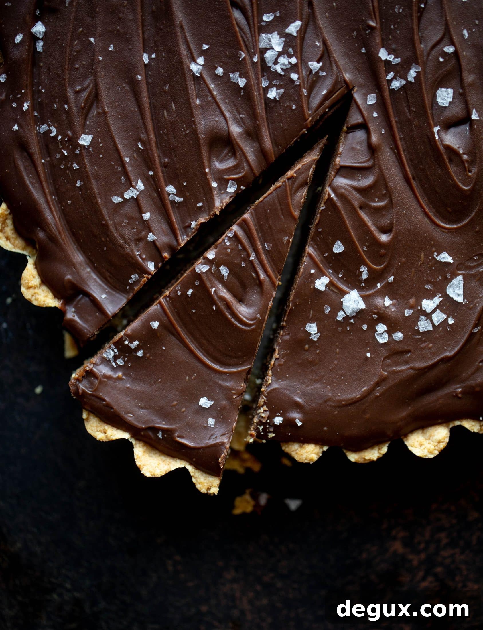 This snickers almond tart is made with an almond crust, homemade almond butter caramel and a chocolate ganache. It's to die for!