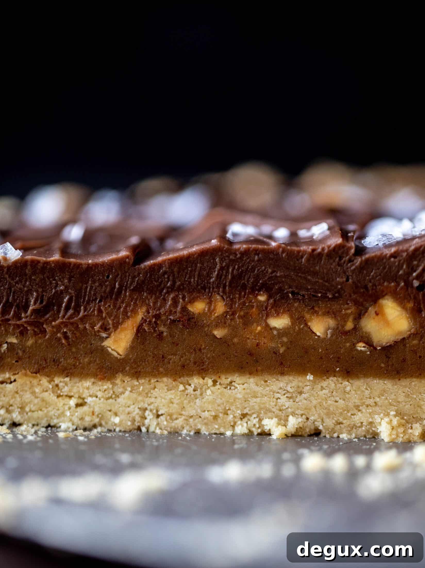 Salted Almond Butter Snickers Tart Recipe 8 This snickers almond tart is made with an almond crust, homemade almond butter caramel and a chocolate ganache. It's to die for!