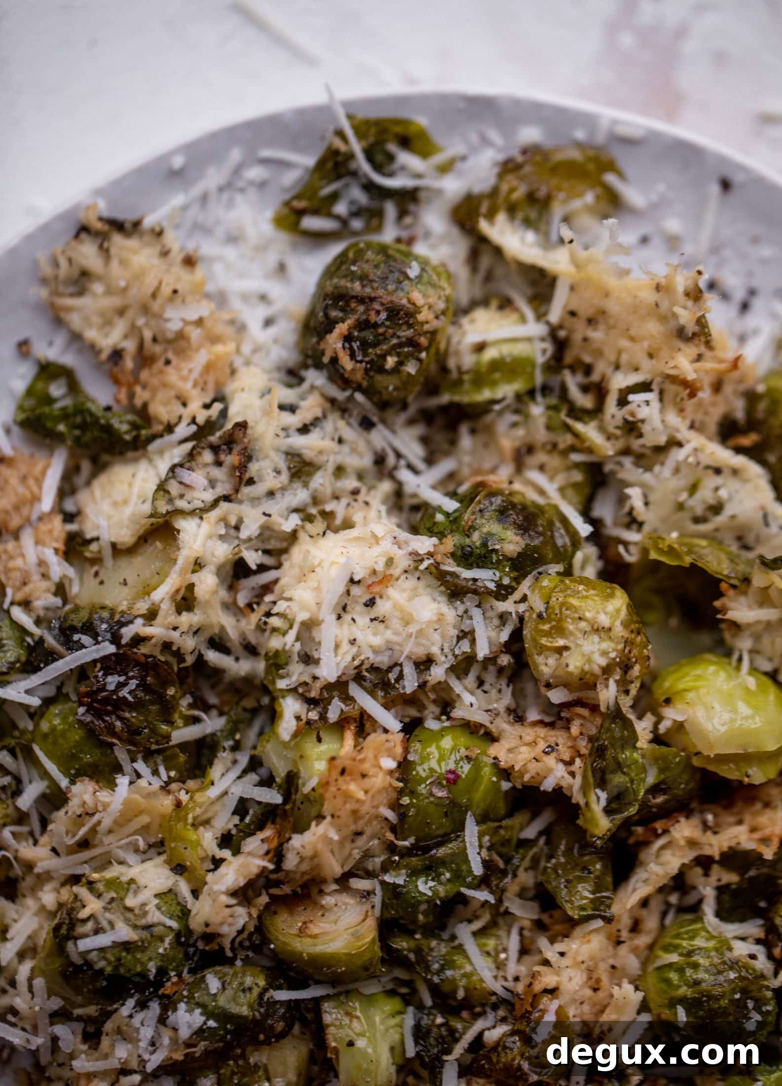 This cacio e pepe brussels are out of the world. Roasted until crisp, topped with tons of black pepper and salty pecorino cheese. Yum.