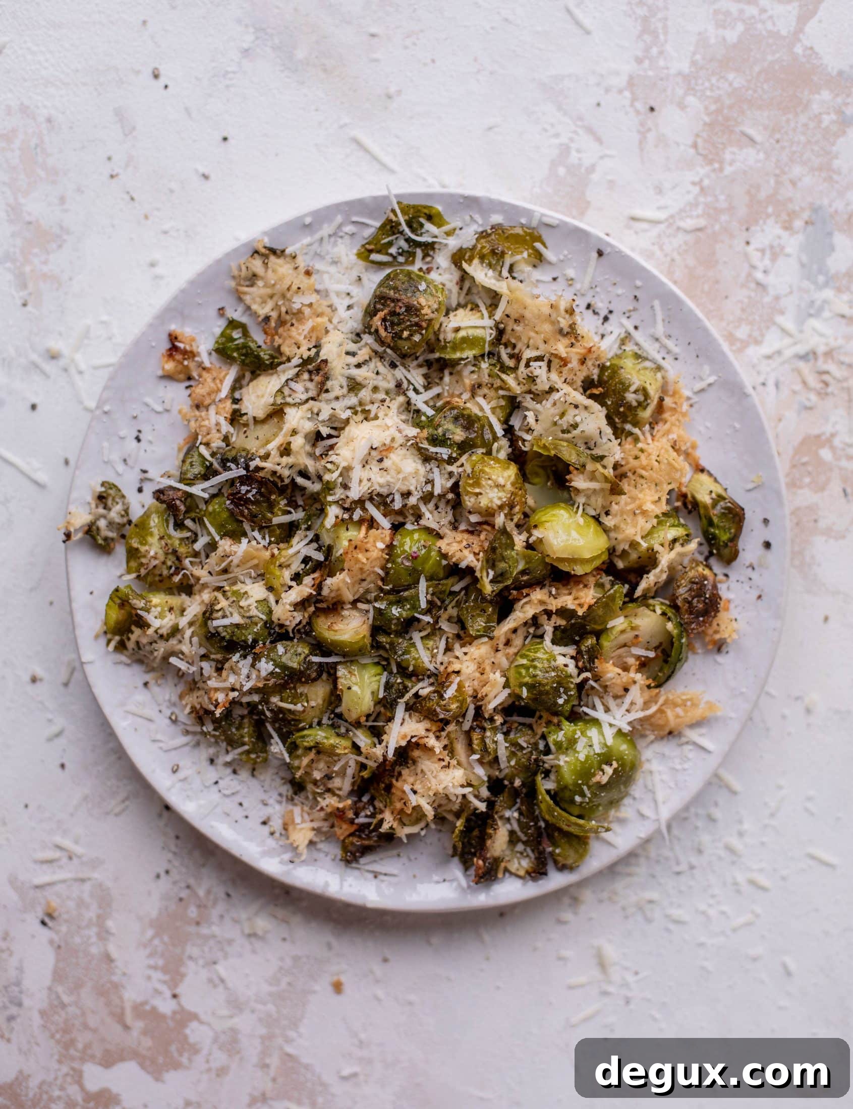 This cacio e pepe brussels are out of the world. Roasted until crisp, topped with tons of black pepper and salty pecorino cheese. Yum.