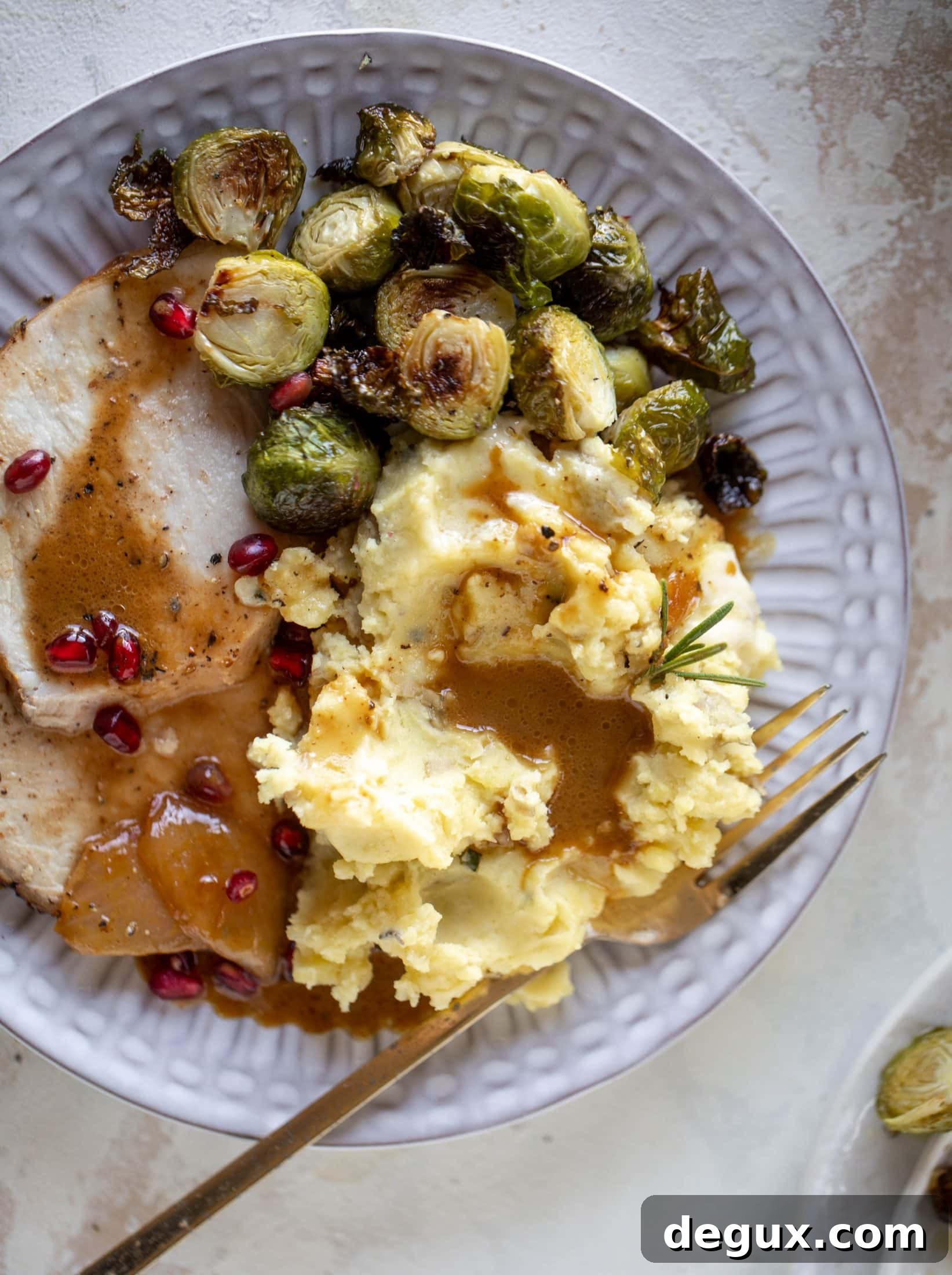Pomegranate Cider Pork Loin Roast with Rosemary Smashed Potatoes 12 This pork loin roast is perfect for the holiday or winter season! Pomegranate and cider glazed, it's wonderful! Serve with smashed rosemary potatoes.