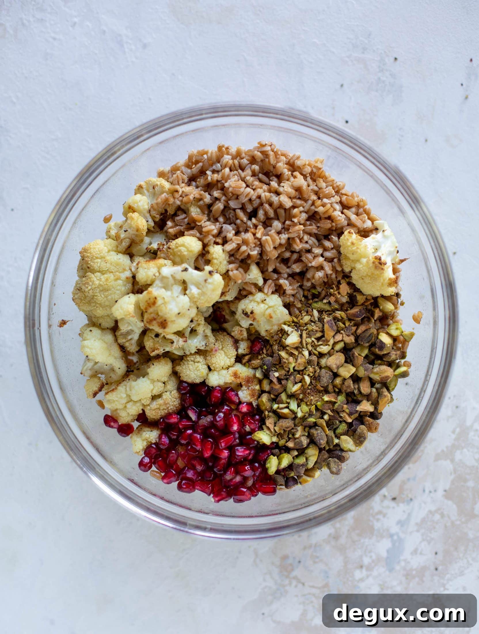 This cauliflower farro salad is filled with roasted cauliflower, pistachios, pomegranates and drizzled with a dill vinaigrette. Delicious!