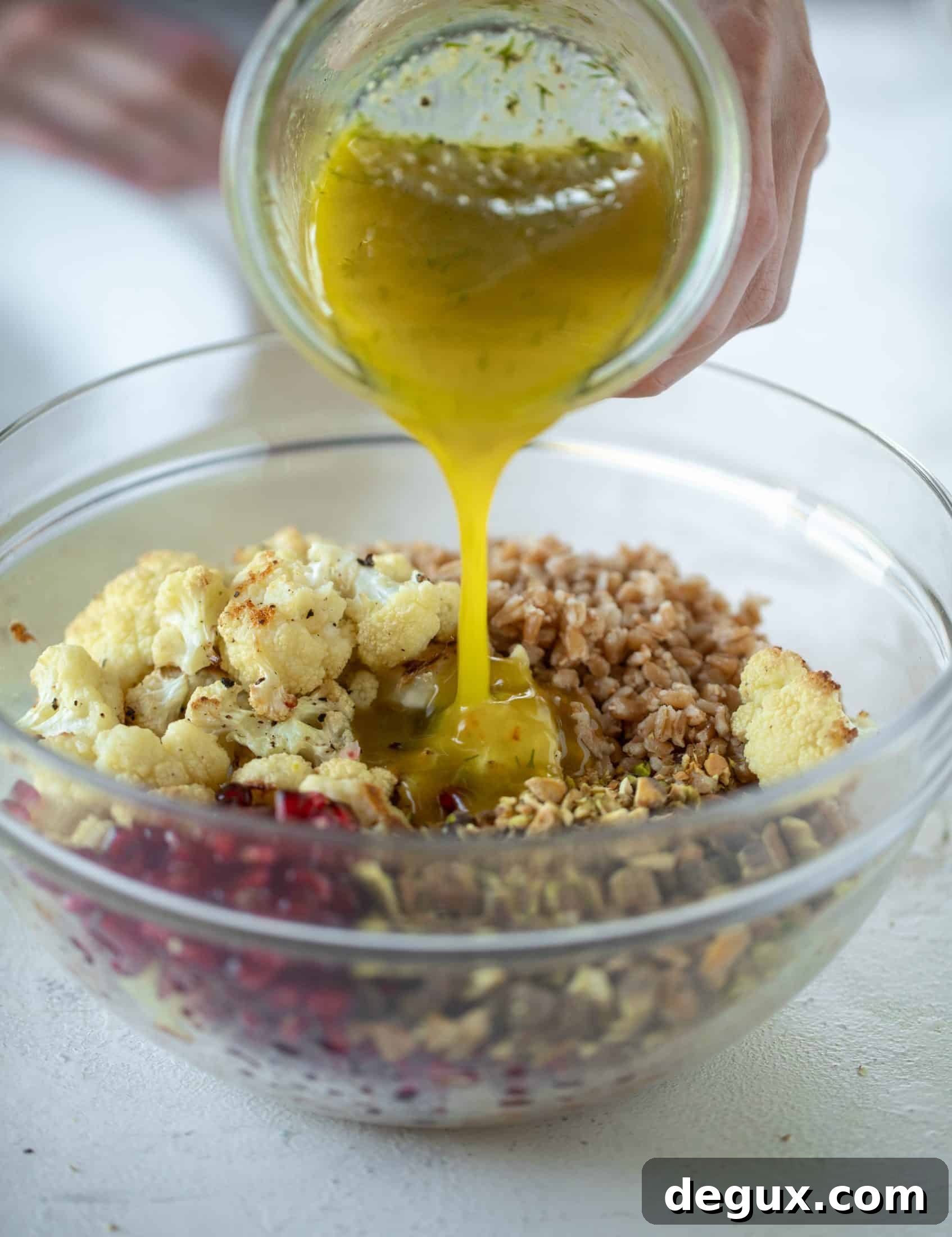 This cauliflower farro salad is filled with roasted cauliflower, pistachios, pomegranates and drizzled with a dill vinaigrette. Delicious!