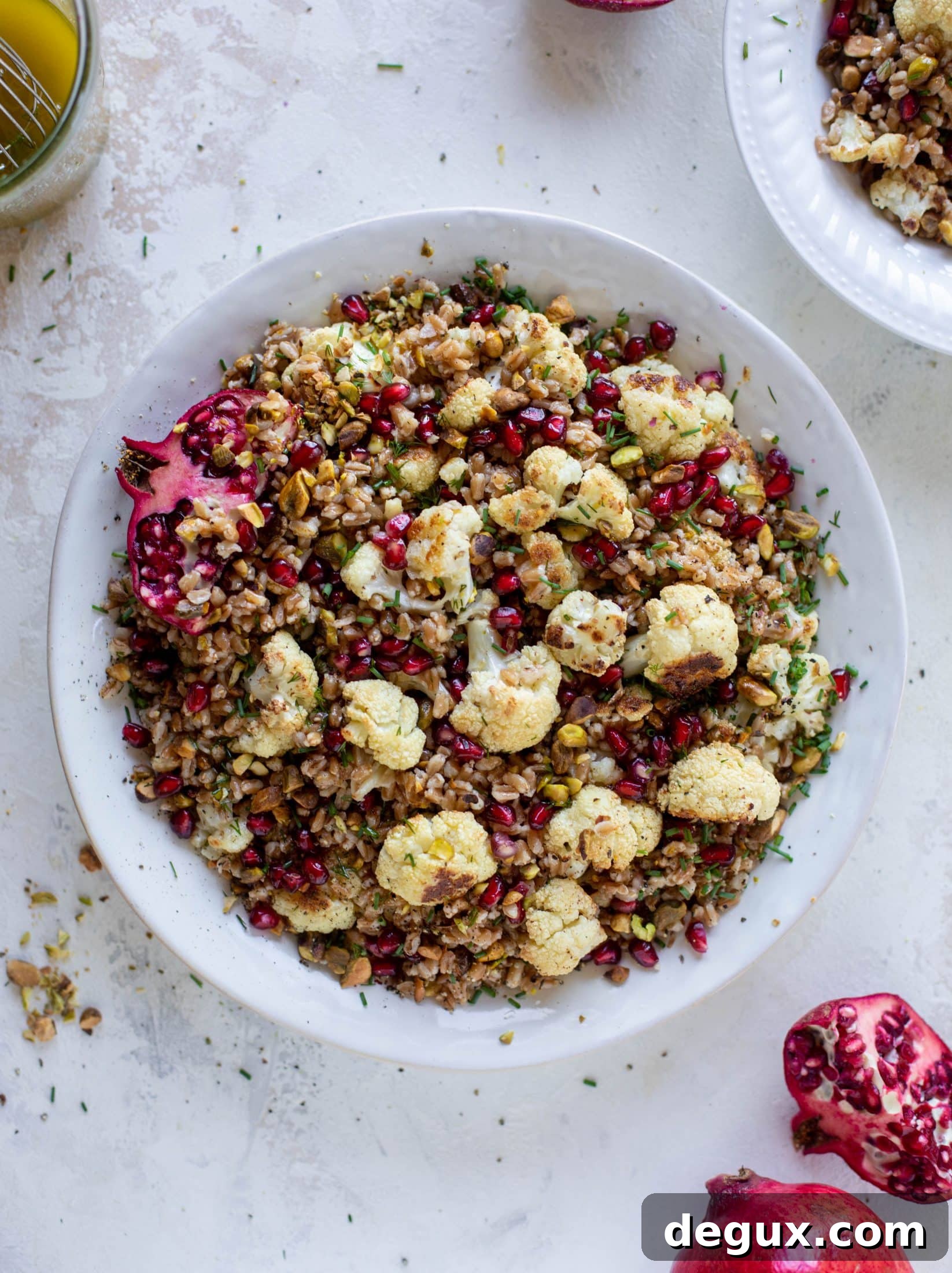 This cauliflower farro salad is filled with roasted cauliflower, pistachios, pomegranates and drizzled with a dill vinaigrette. Delicious!
