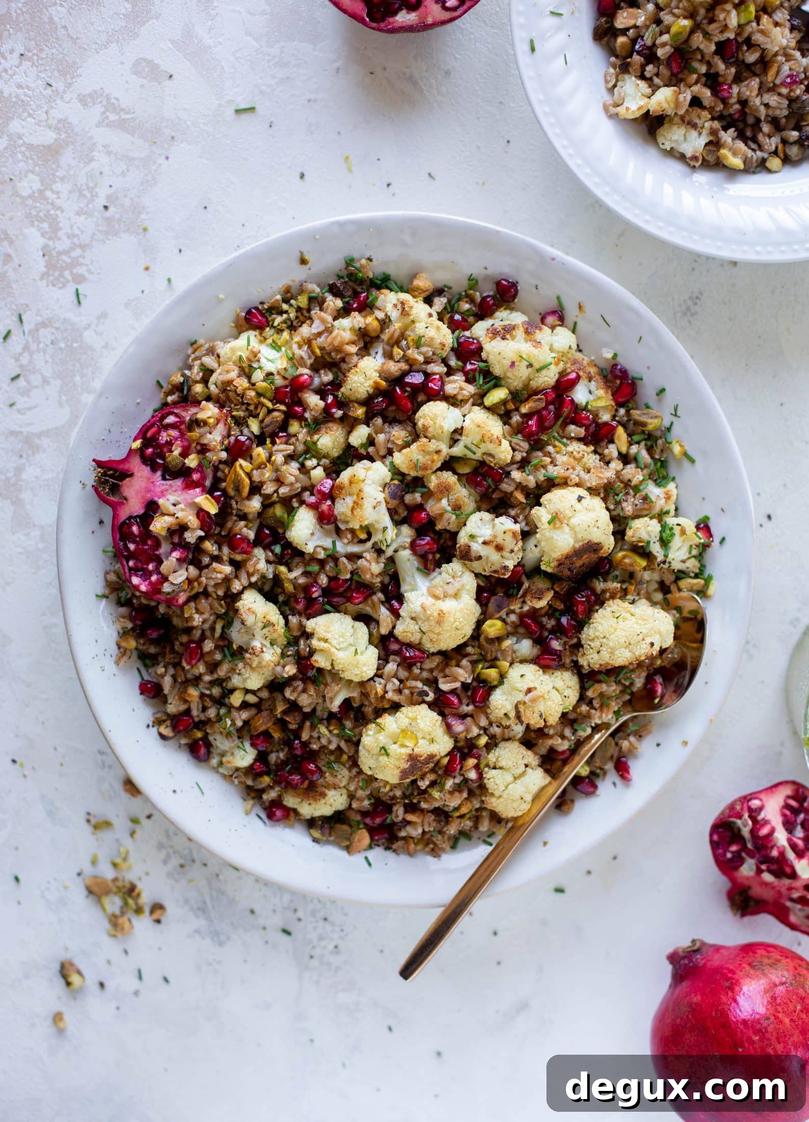 This cauliflower farro salad is filled with roasted cauliflower, pistachios, pomegranates and drizzled with a dill vinaigrette. Delicious!