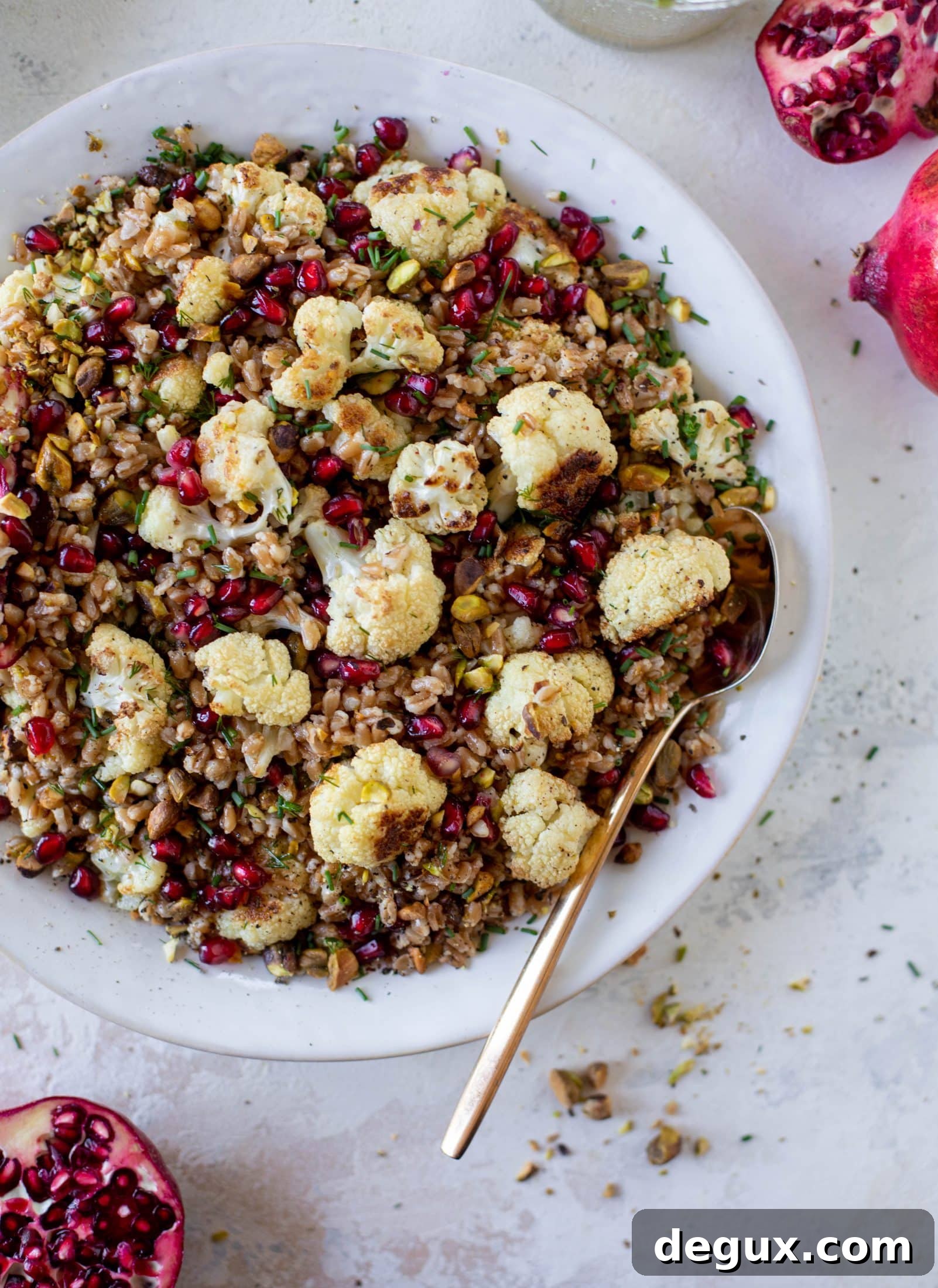 This cauliflower farro salad is filled with roasted cauliflower, pistachios, pomegranates and drizzled with a dill vinaigrette. Delicious!