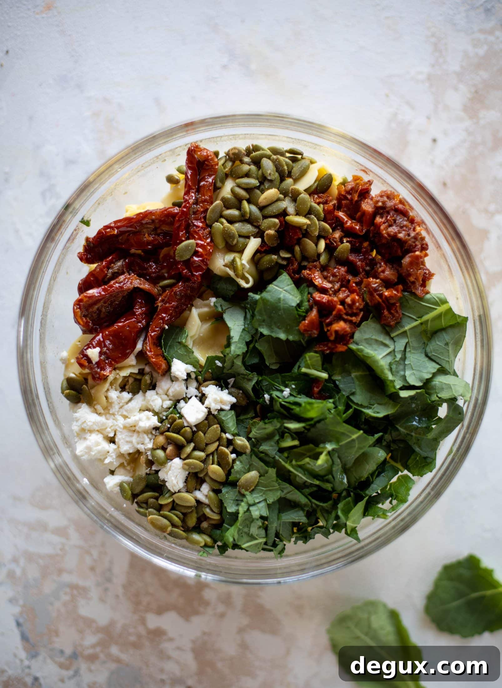 This cilantro lime tortellini salad is loaded with flavor! Served warm or cold, it has pepitas, sun dried tomatoes and crumbled feta. It's ridiculously good!