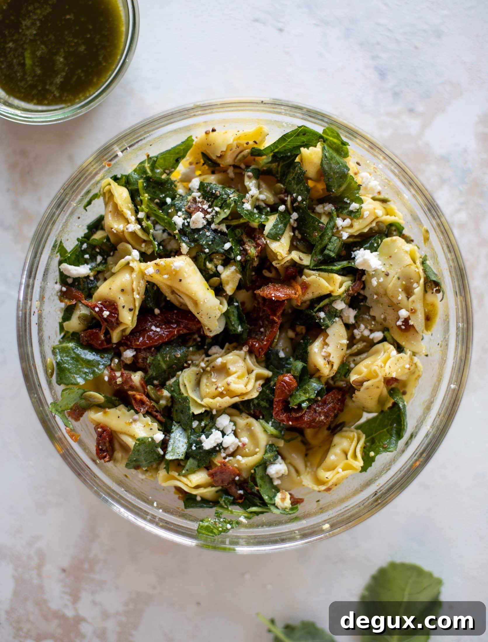 This cilantro lime tortellini salad is loaded with flavor! Served warm or cold, it has pepitas, sun dried tomatoes and crumbled feta. It's ridiculously good!