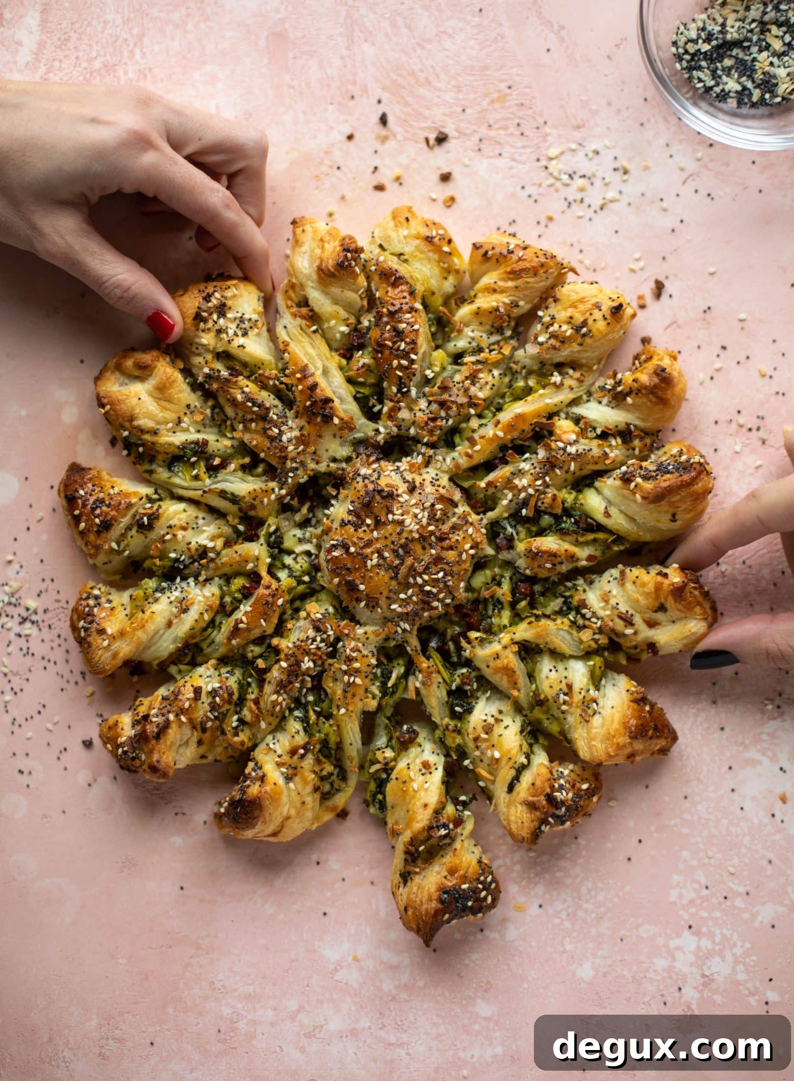 These spinach artichoke twists are filled with cheese and pancetta. They are buttery and flaky on the outside then sprinkled with everything seasoning. YUM.
