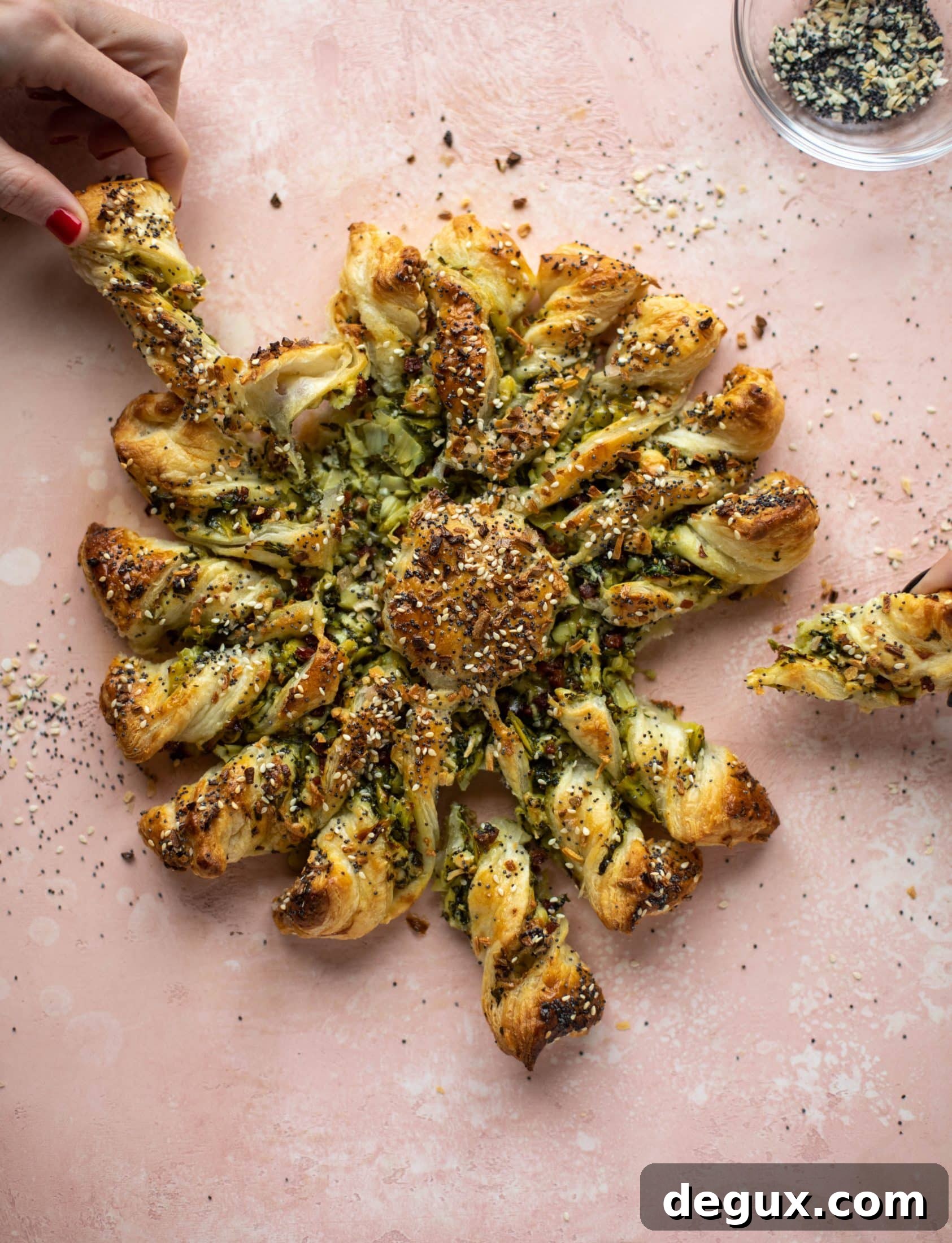 These spinach artichoke twists are filled with cheese and pancetta. They are buttery and flaky on the outside then sprinkled with everything seasoning. YUM.