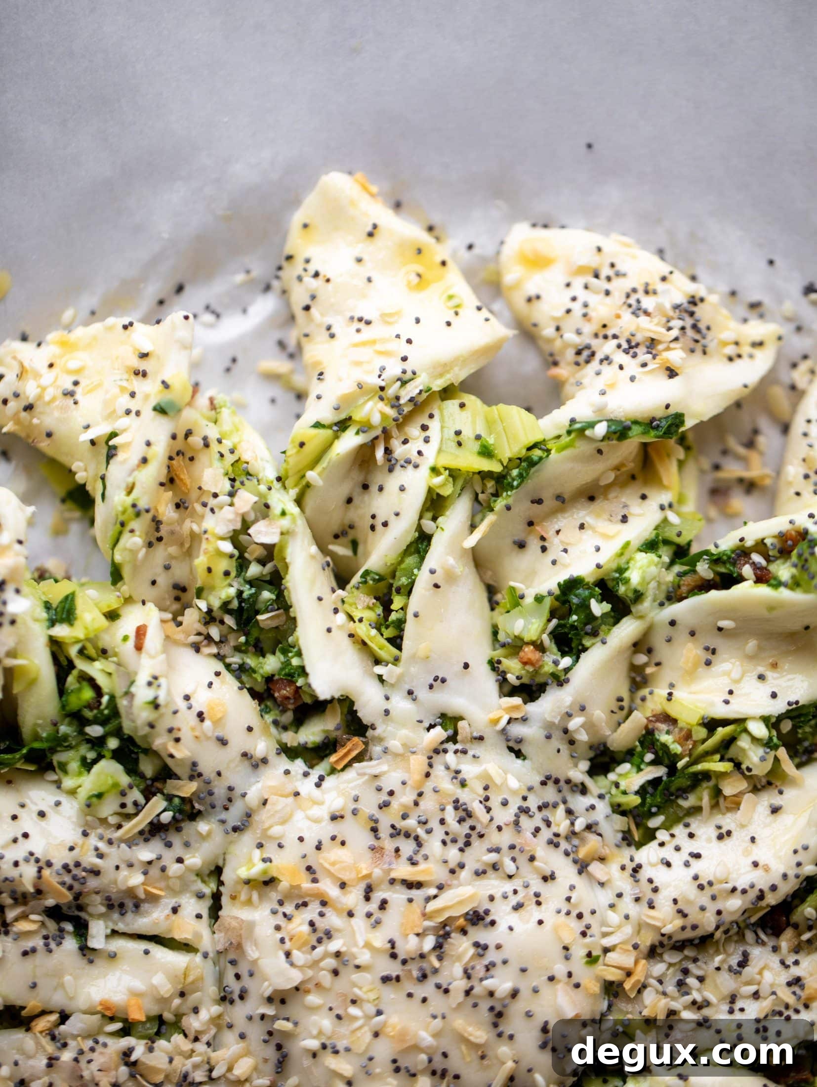 These spinach artichoke twists are filled with cheese and pancetta. They are buttery and flaky on the outside then sprinkled with everything seasoning. YUM.