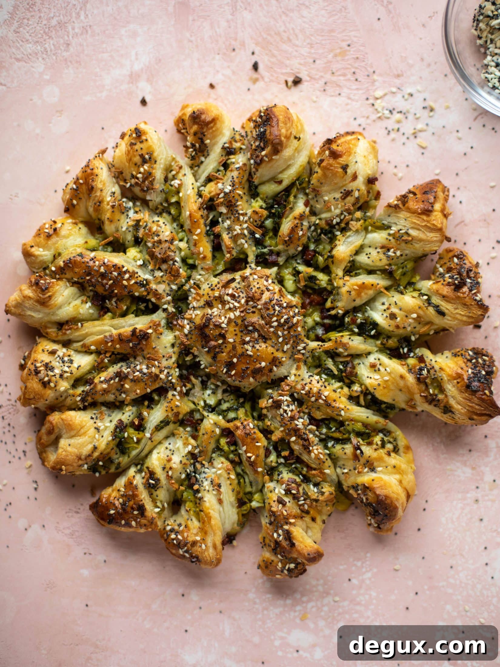 These spinach artichoke twists are filled with cheese and pancetta. They are buttery and flaky on the outside then sprinkled with everything seasoning. YUM.