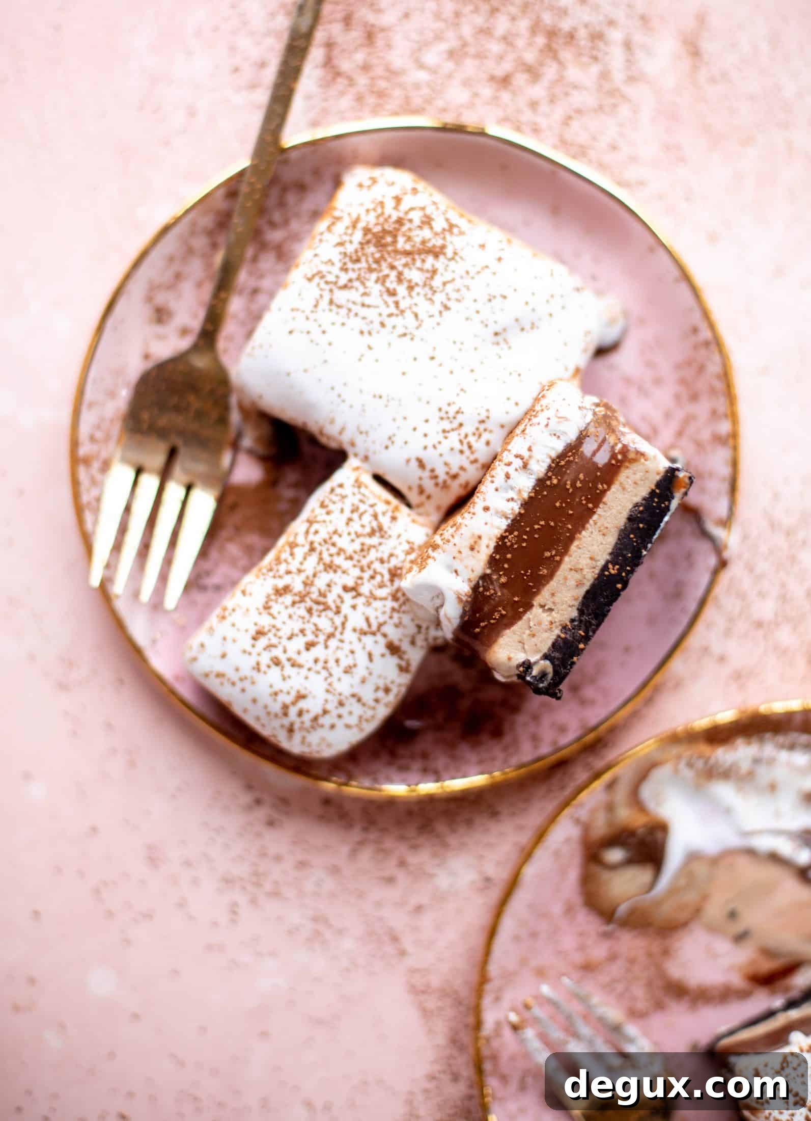This frozen chocolate cookie dessert is a twist on the classic 90s recipe! Cookie crust, ice cream, homemade hot fudge and whipped cream. It's amazing!