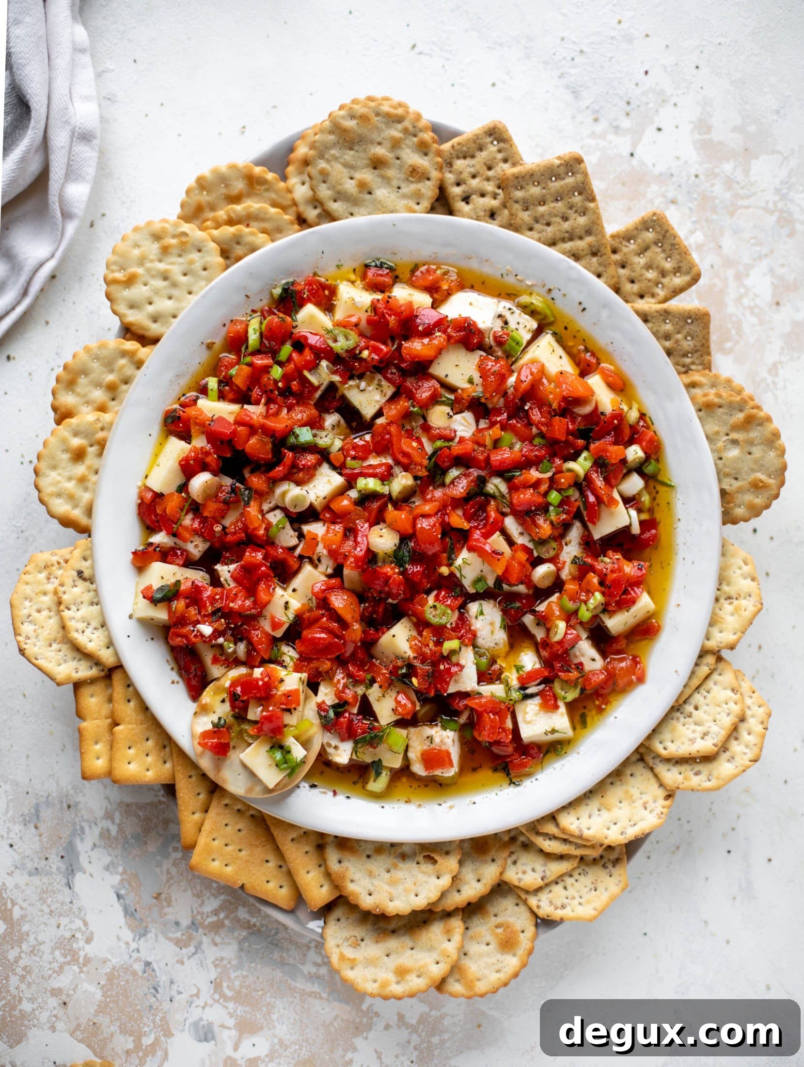 This marinated cheese recipe is perfect for Christmas! Make it ahead and transport it easily to your destination. It's absolutely delicious.