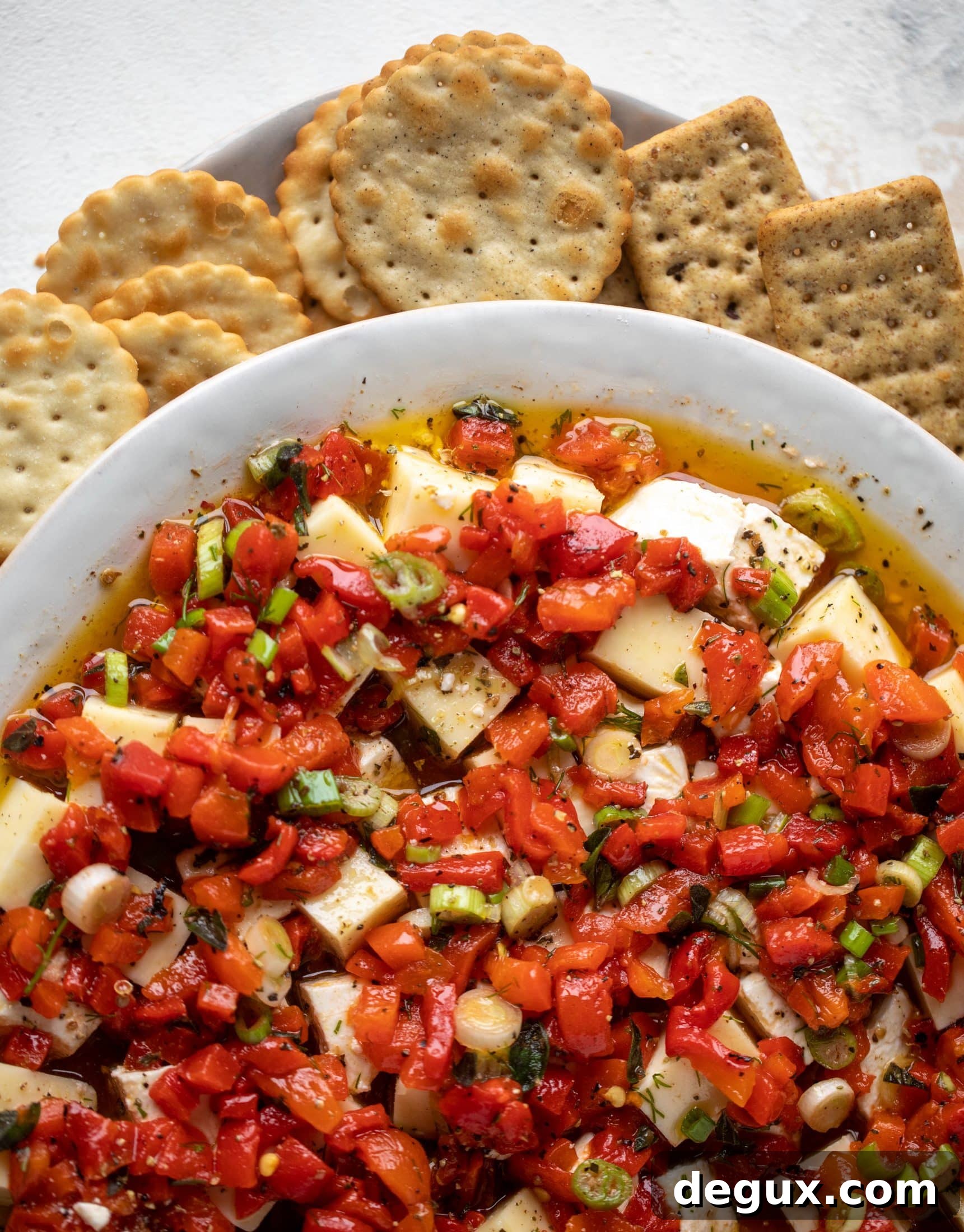 This marinated cheese recipe is perfect for Christmas! Make it ahead and transport it easily to your destination. It's absolutely delicious.