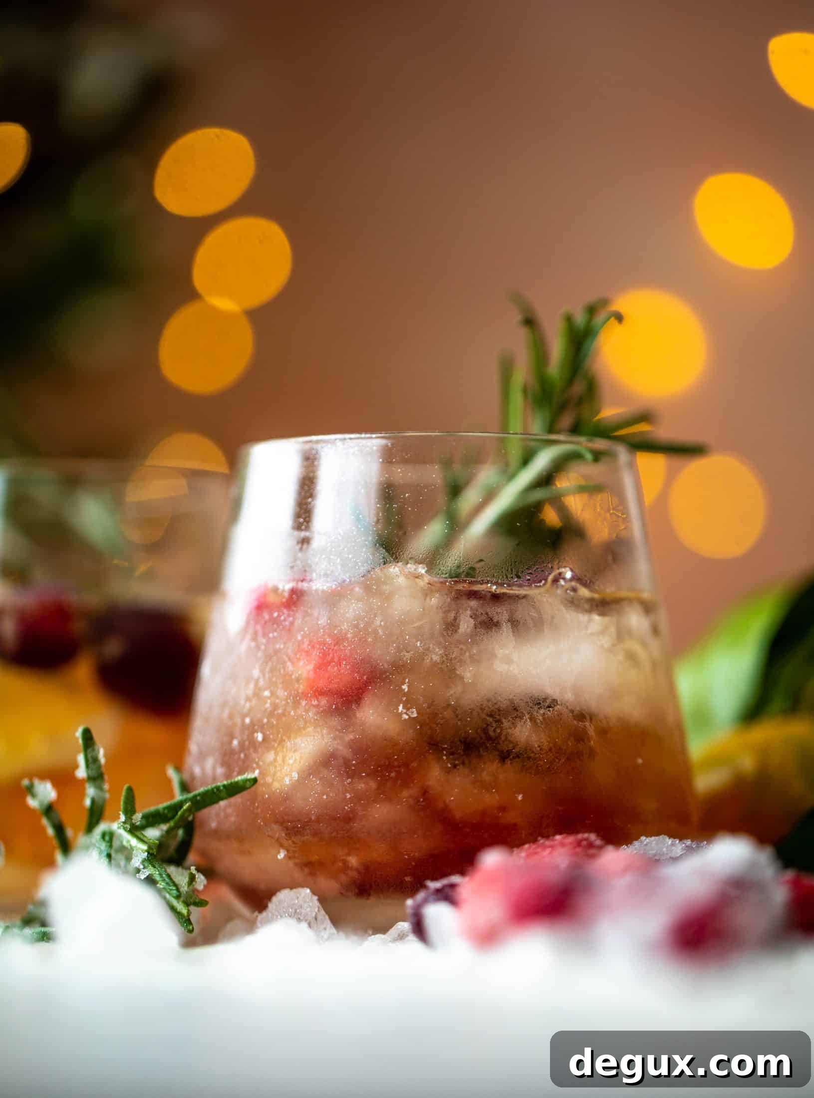 The mistletoe manhattan is a fun holiday spin on the classic manhattan cocktail! Sugared cranberries and rosemary make this super festive.