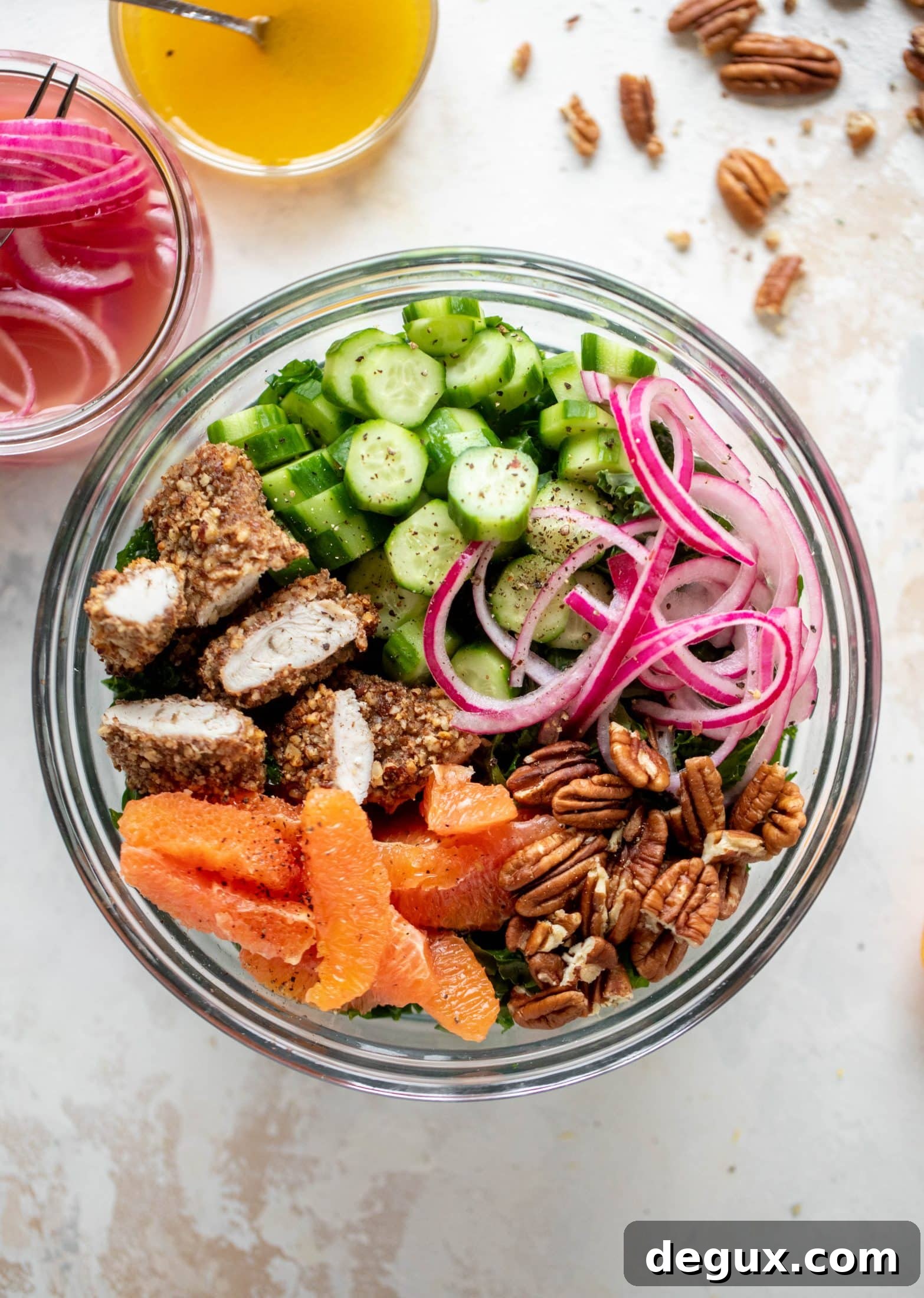This pecan crusted chicken salad is so hearty! Kale, cara cara oranges, pickled onions, cucumbers and pecorino make this a bowl of flavor.