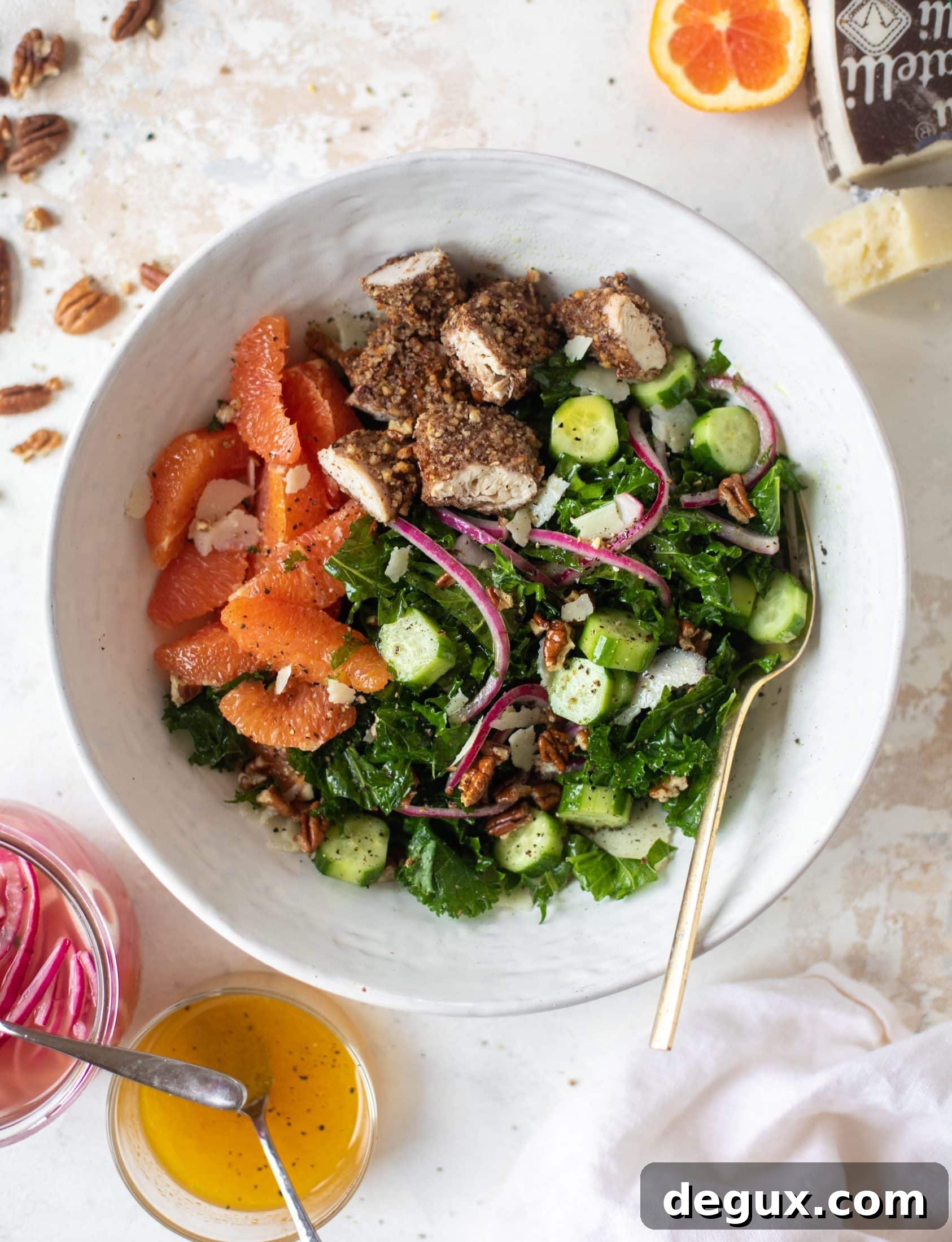 This pecan crusted chicken salad is so hearty! Kale, cara cara oranges, pickled onions, cucumbers and pecorino make this a bowl of flavor.