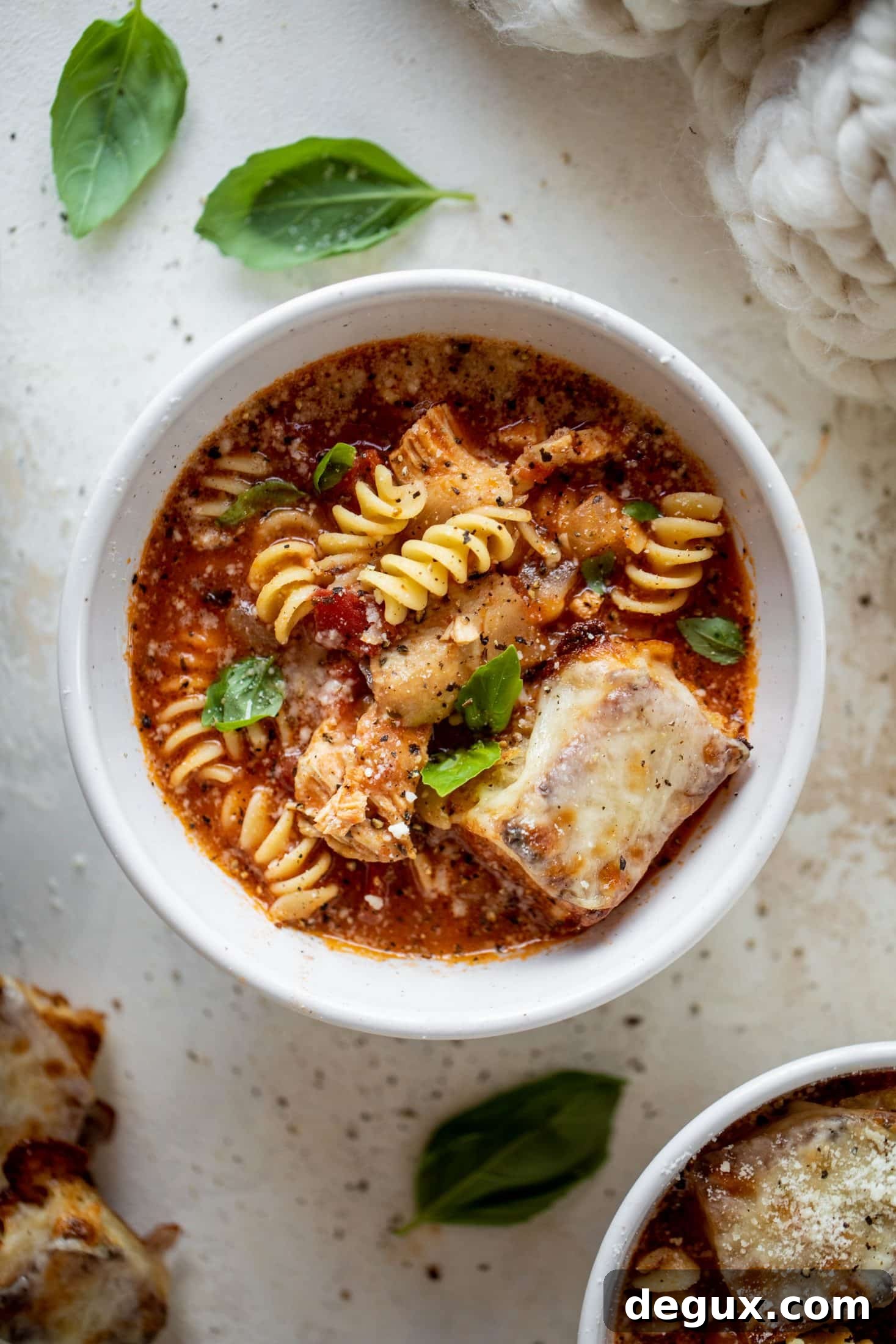 This chicken parmesan soup is ridiculously flavorful and so easy to make! Juicy chicken with pasta, fire roasted tomatoes and mozzarella croutons.
