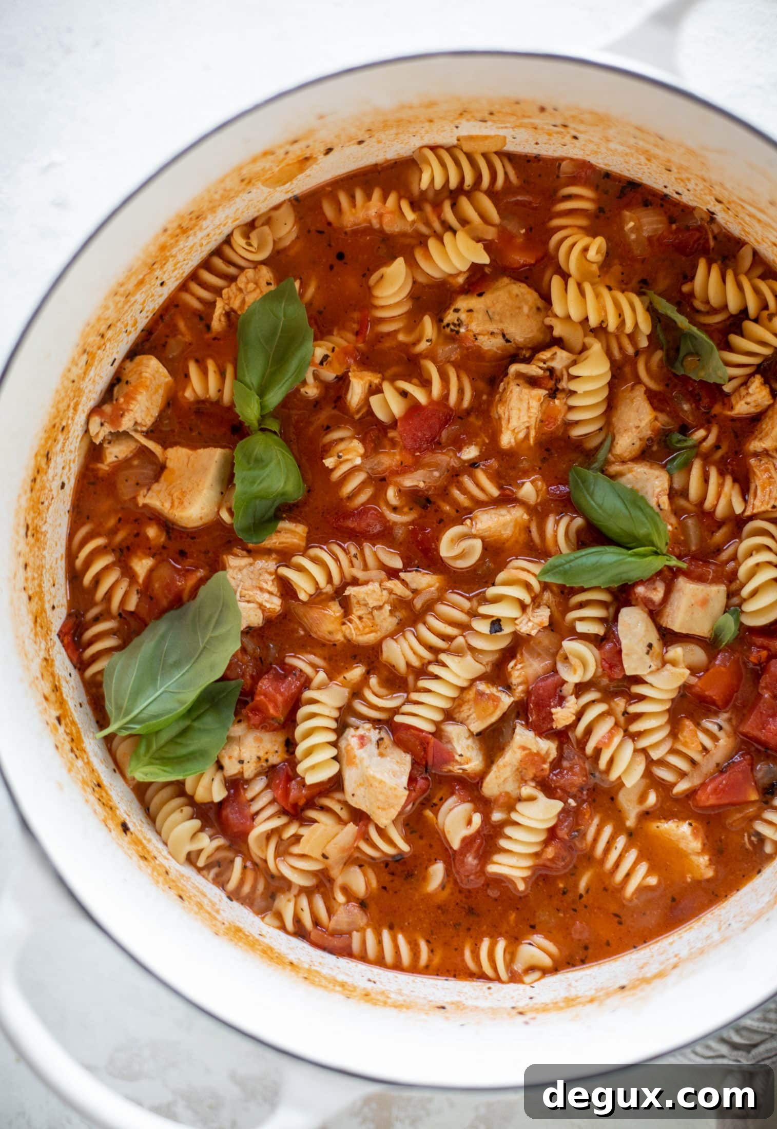 This chicken parmesan soup is ridiculously flavorful and so easy to make! Juicy chicken with pasta, fire roasted tomatoes and mozzarella croutons.