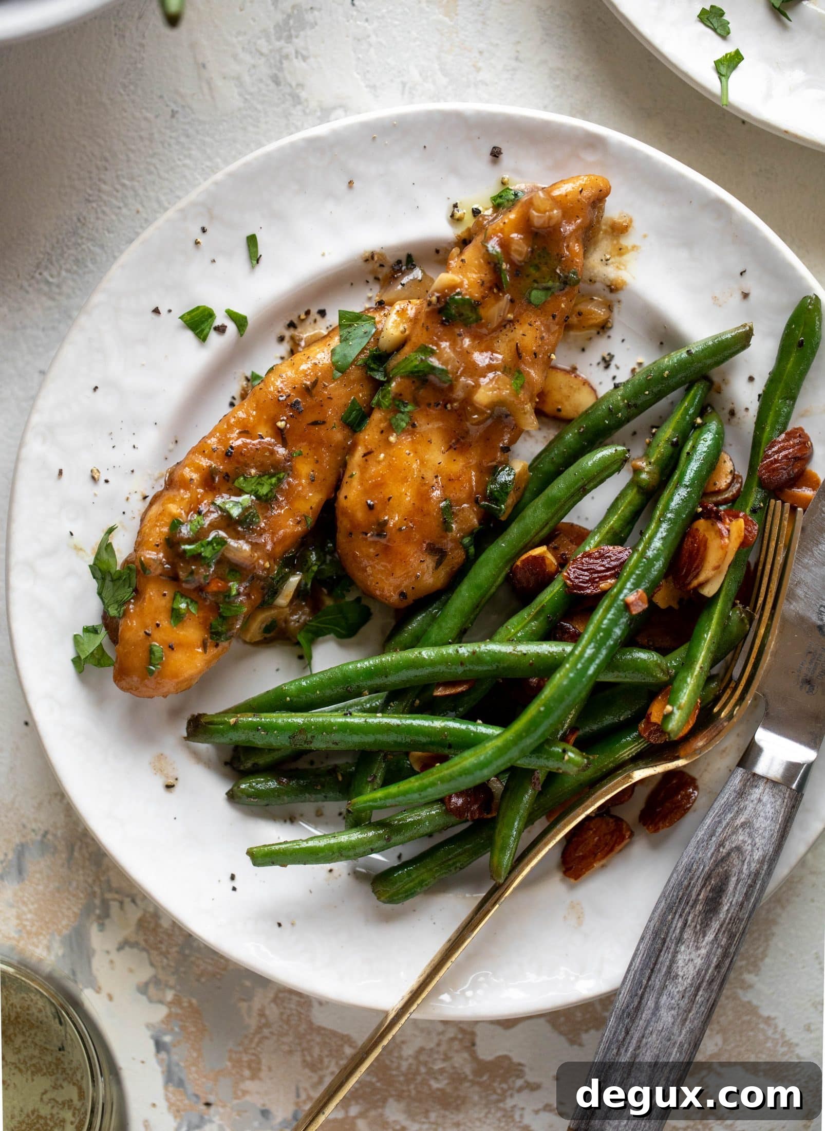 My mom's chicken marsala is easy and ridiculously flavorful! It's made without mushrooms and served alongside almond brown butter green beans.