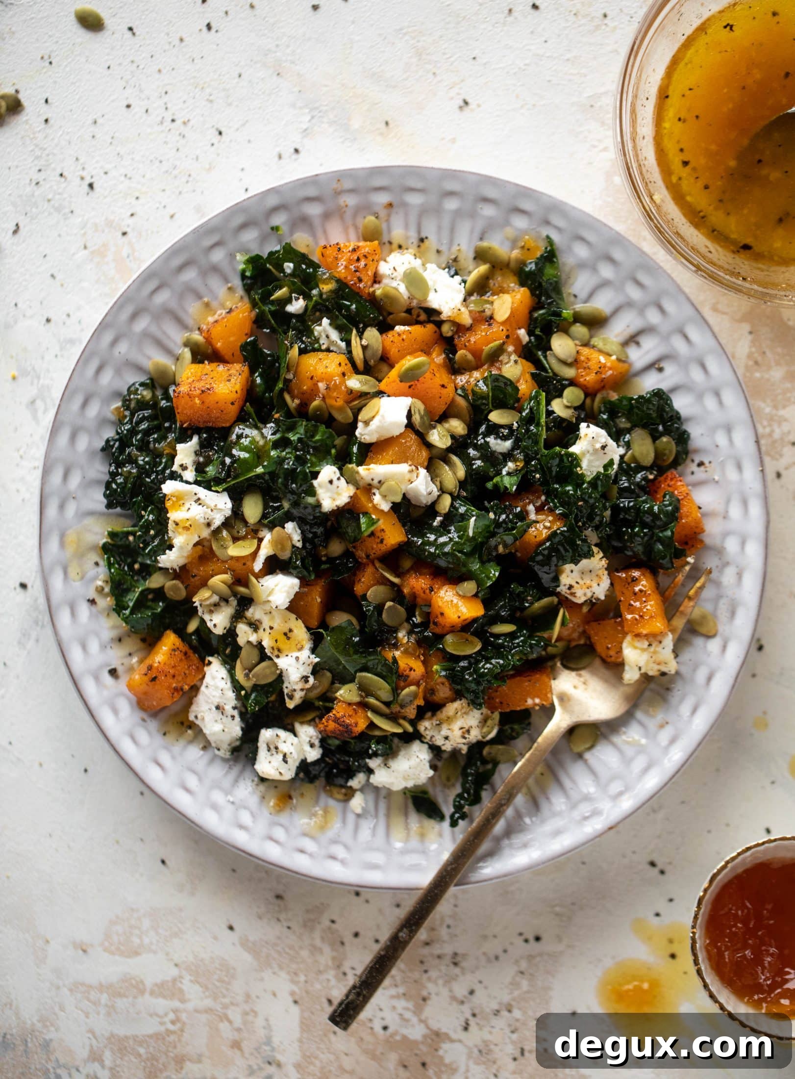 This butternut squash kale salad is so easy and delicious! Roasted, smoky butternut squash, goat cheese, pepitas and apricot vinaigrette.