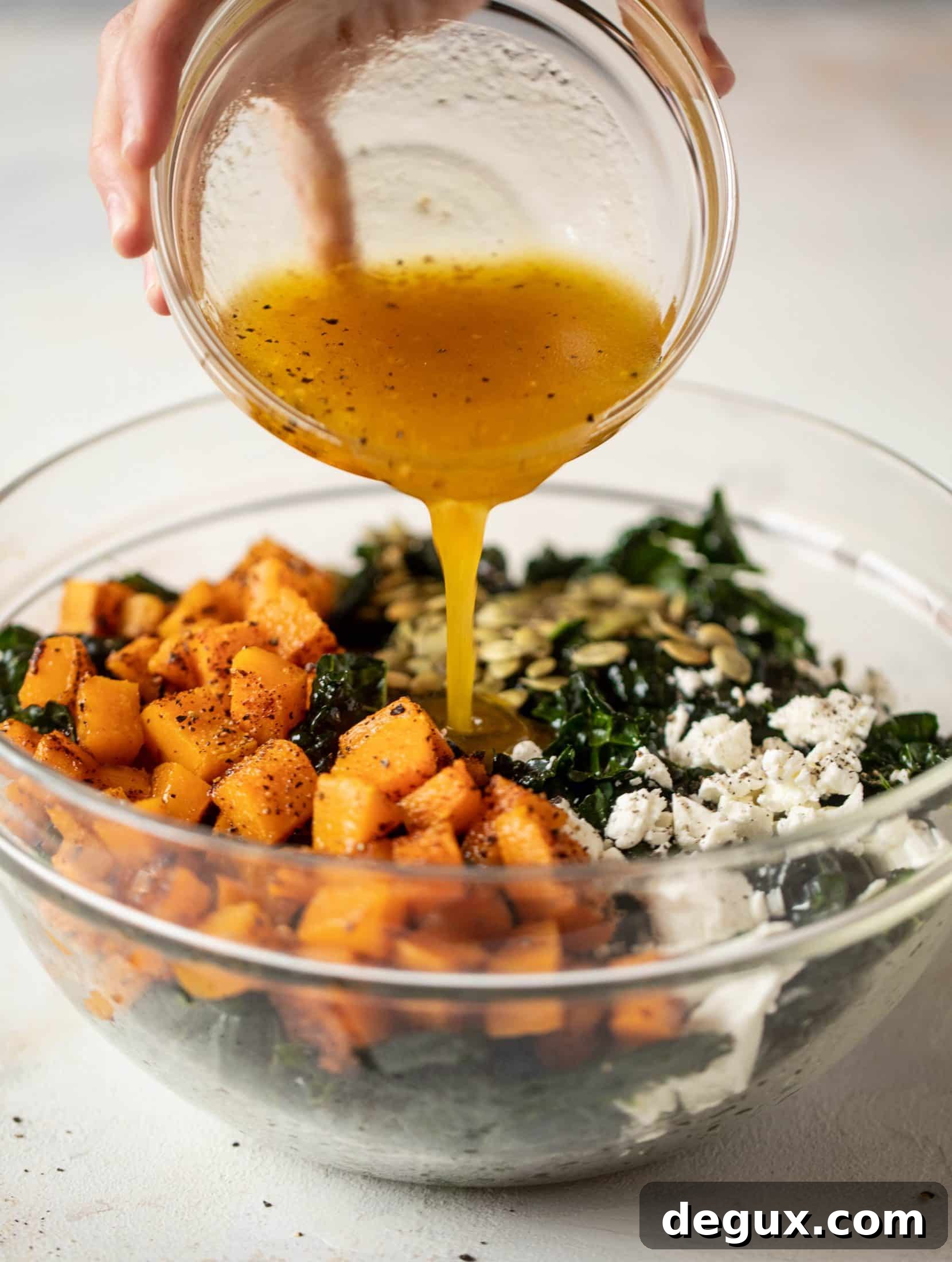 This butternut squash kale salad is so easy and delicious! Roasted, smoky butternut squash, goat cheese, pepitas and apricot vinaigrette.