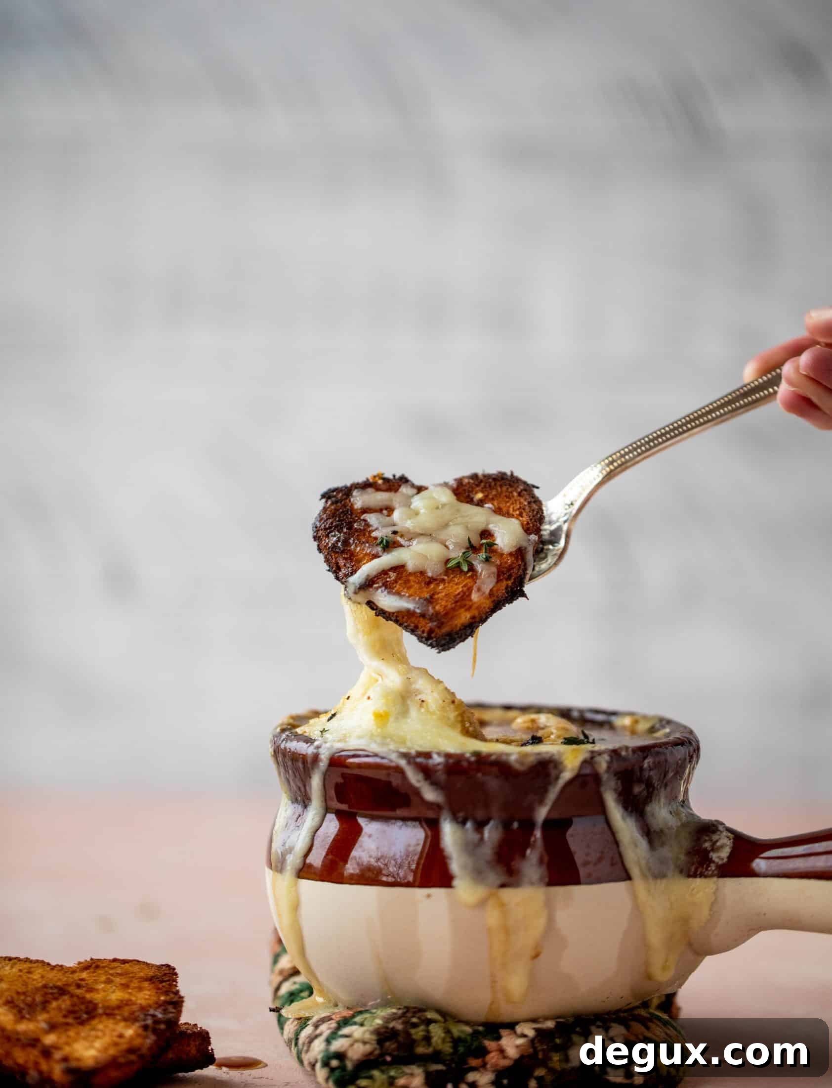 My favorite french onion soup starts with bourbon caramelized onions! Adorable heart croutons and tons of gruyere take it over the top.