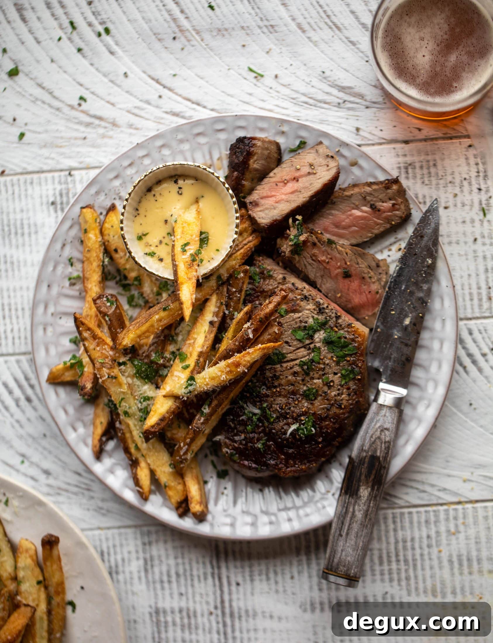 This is our favorite steak frites! Seared skillet steak and crispy fries made in the air fryer, topped with truffle salt, parmesan and herbs!