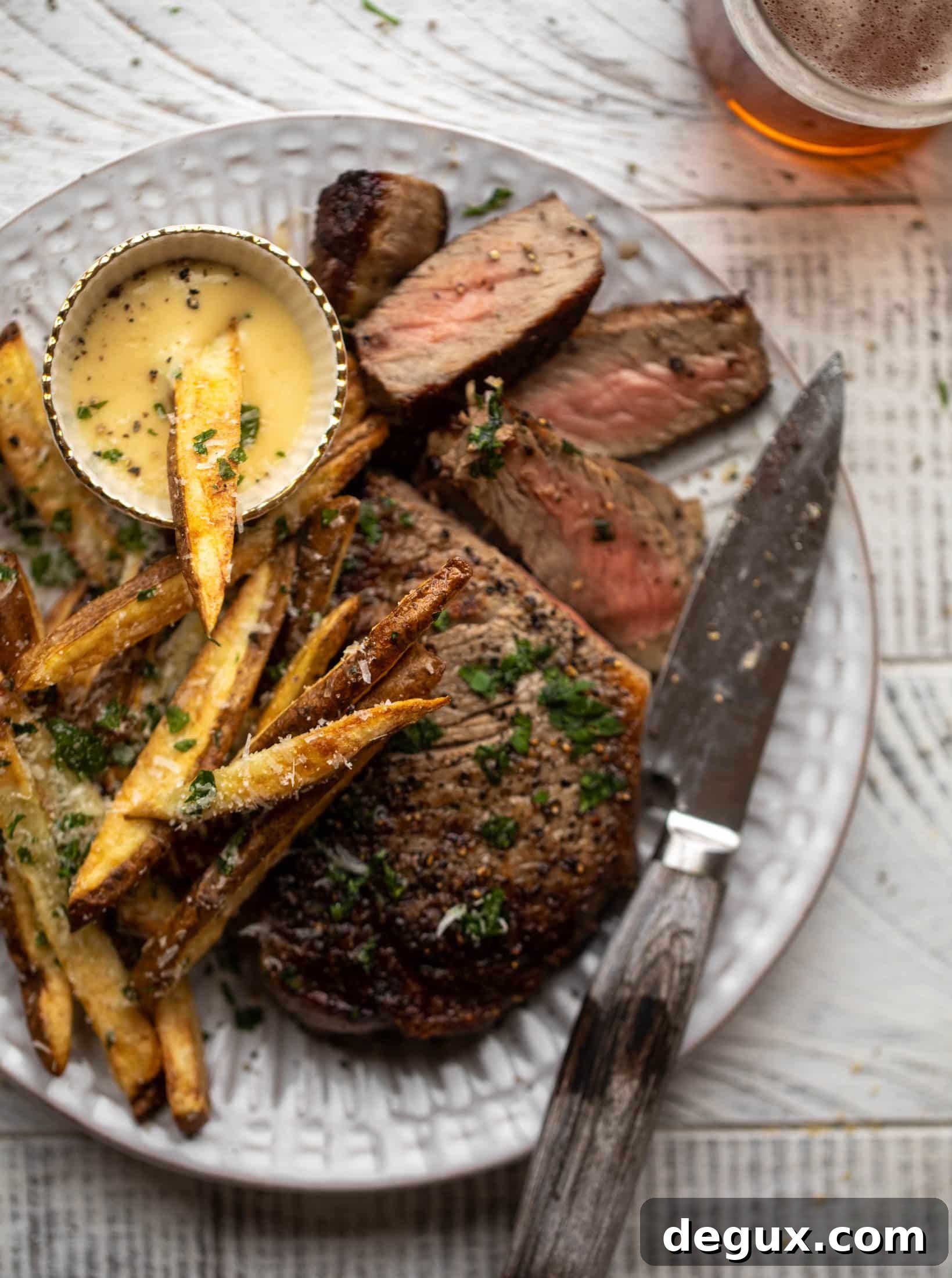 This is our favorite steak frites! Seared skillet steak and crispy fries made in the air fryer, topped with truffle salt, parmesan and herbs!