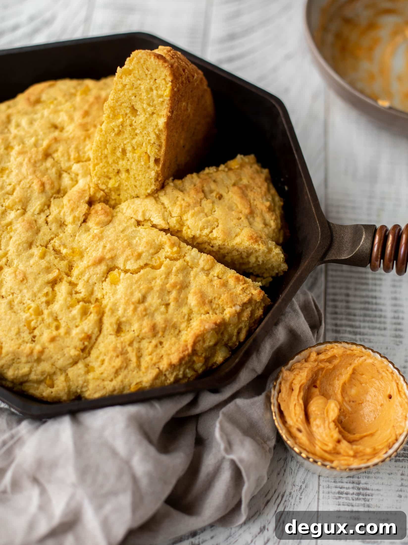 This skillet cornbread is so fluffy and delicious! Serve it hot from the oven with chipotle honey butter. It makes a great appetizer or side dish.