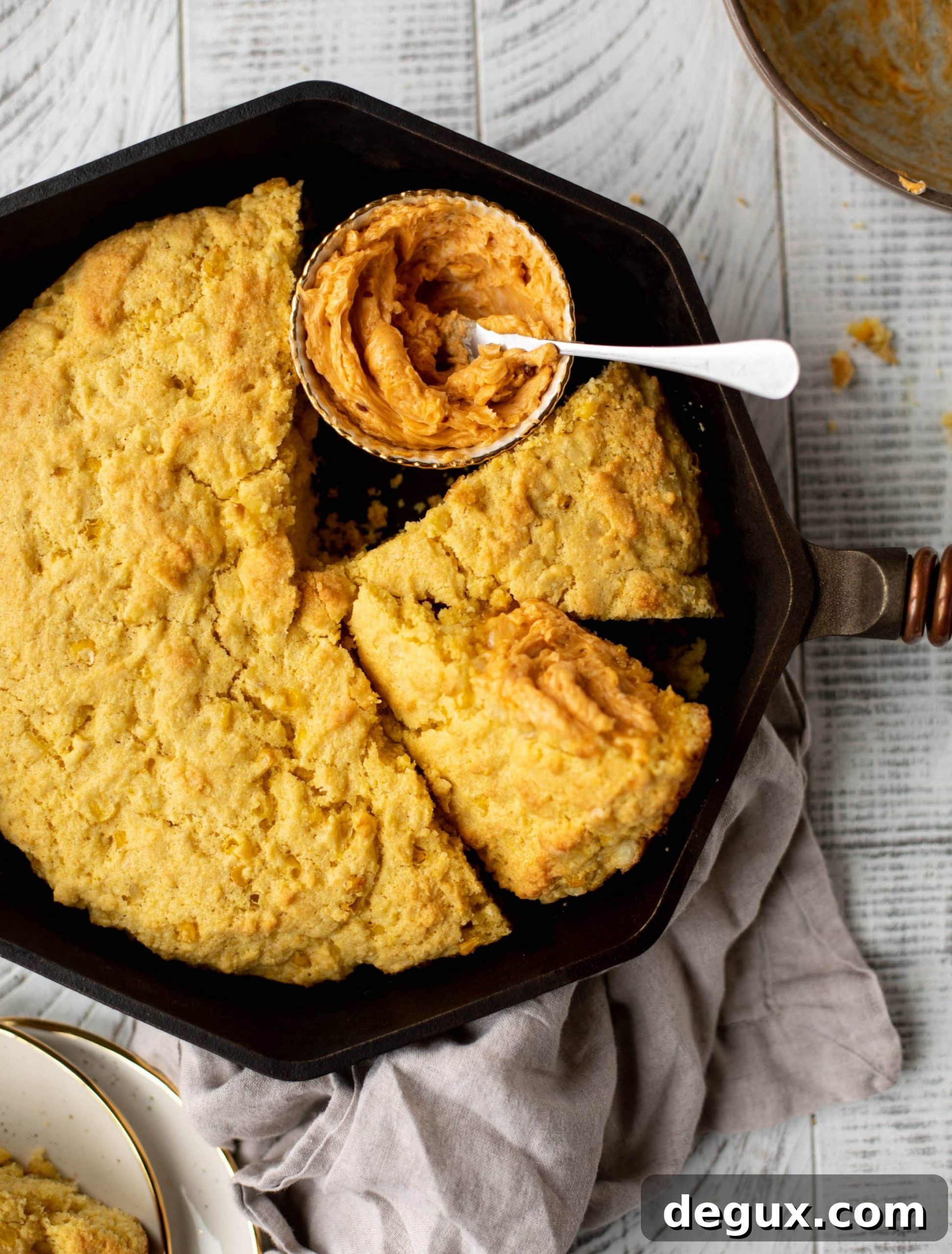 This skillet cornbread is so fluffy and delicious! Serve it hot from the oven with chipotle honey butter. It makes a great appetizer or side dish.