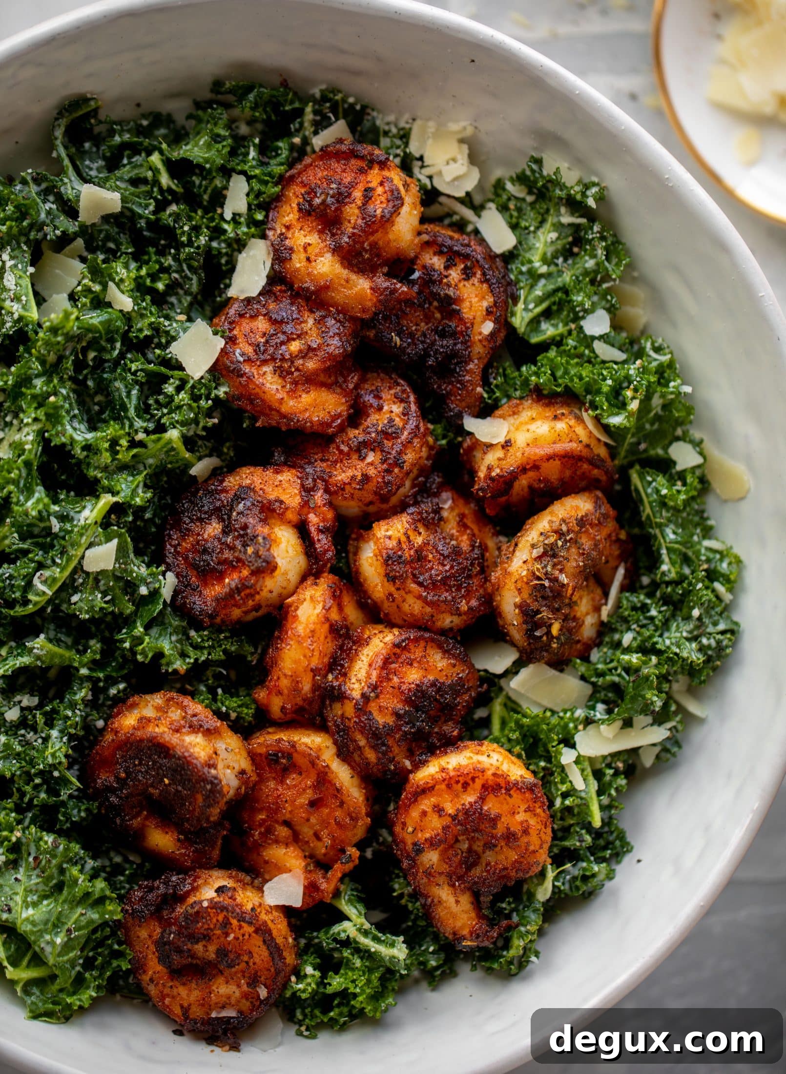 This blackened shrimp kale caesar is loaded with flavor. Spiced, buttery shrimp pan fried until golden, then thrown on kale caesar salad. Delish!