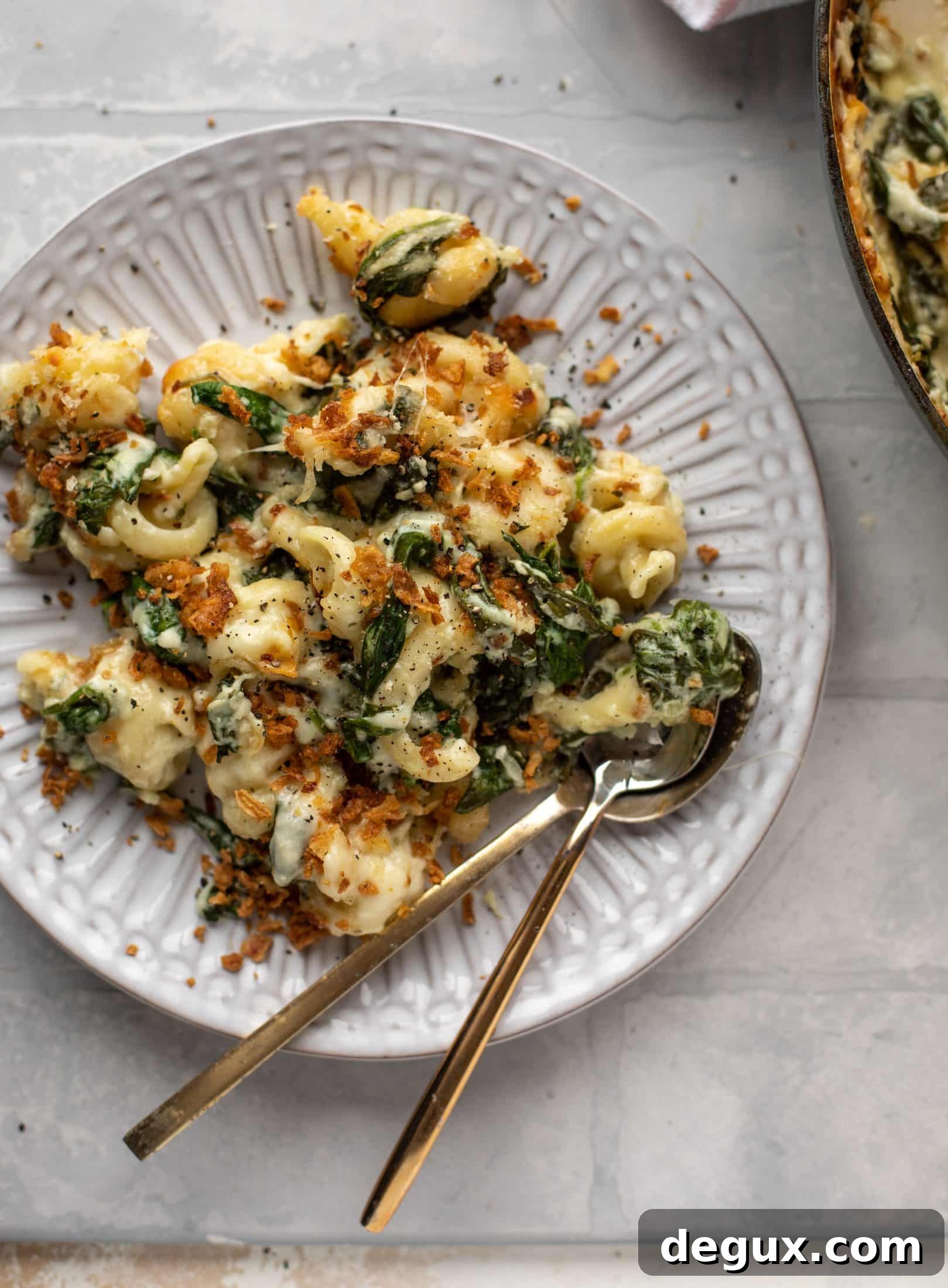 This creamed spinach mac and cheese is a dreamy, cheesy mac and cheese dish with tons of fresh baby spinach! Super comforting and flavorful. 