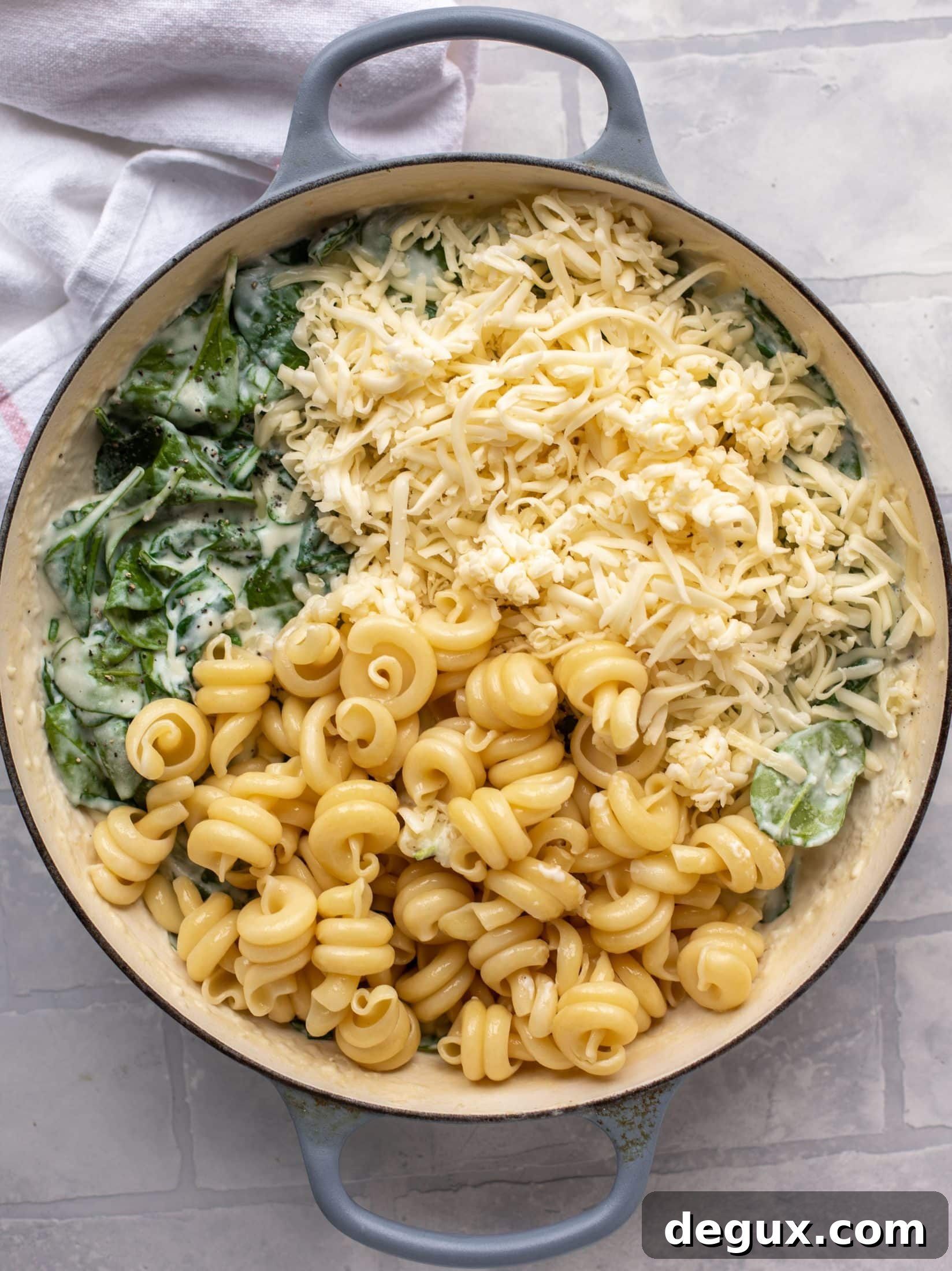 This creamed spinach mac and cheese is a dreamy, cheesy mac and cheese dish with tons of fresh baby spinach! Super comforting and flavorful. 