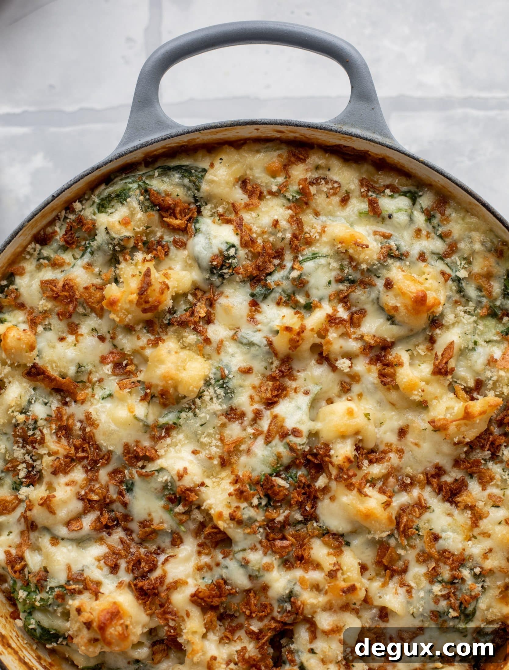 This creamed spinach mac and cheese is a dreamy, cheesy mac and cheese dish with tons of fresh baby spinach! Super comforting and flavorful. 