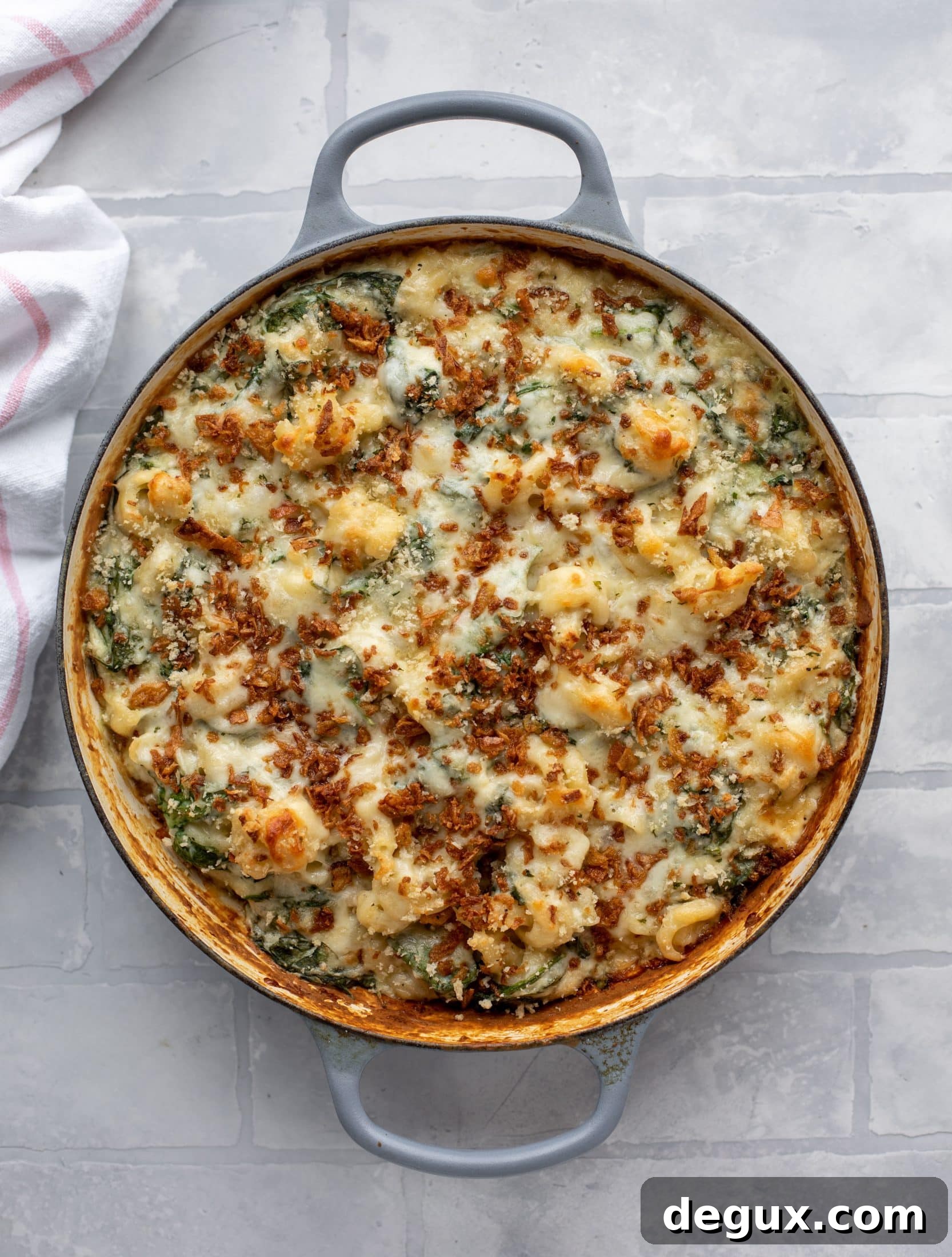This creamed spinach mac and cheese is a dreamy, cheesy mac and cheese dish with tons of fresh baby spinach! Super comforting and flavorful. 