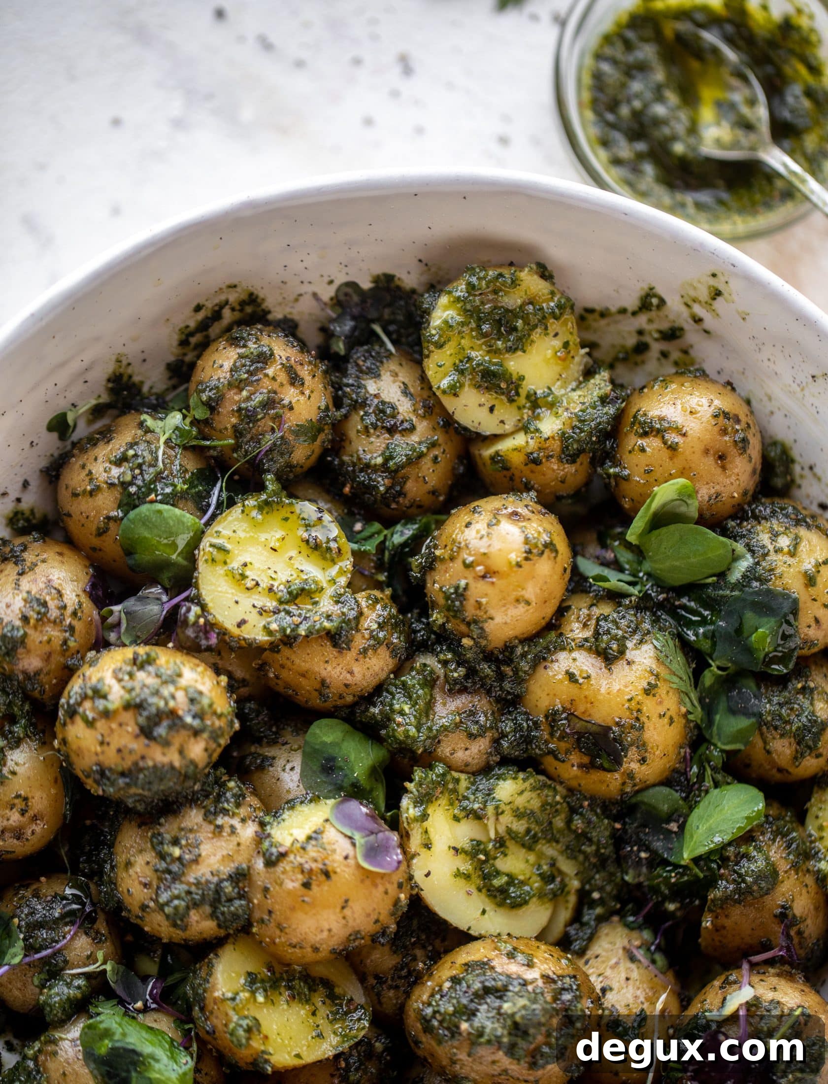 Carrot Top Pesto Potato Salad Recipe — Bright, Herbaceous Side Dish 11 This pesto potato salad is made with carrot top pesto for the perfect spring side dish! Baby potatoes, pesto and greens make up this delish bowl.