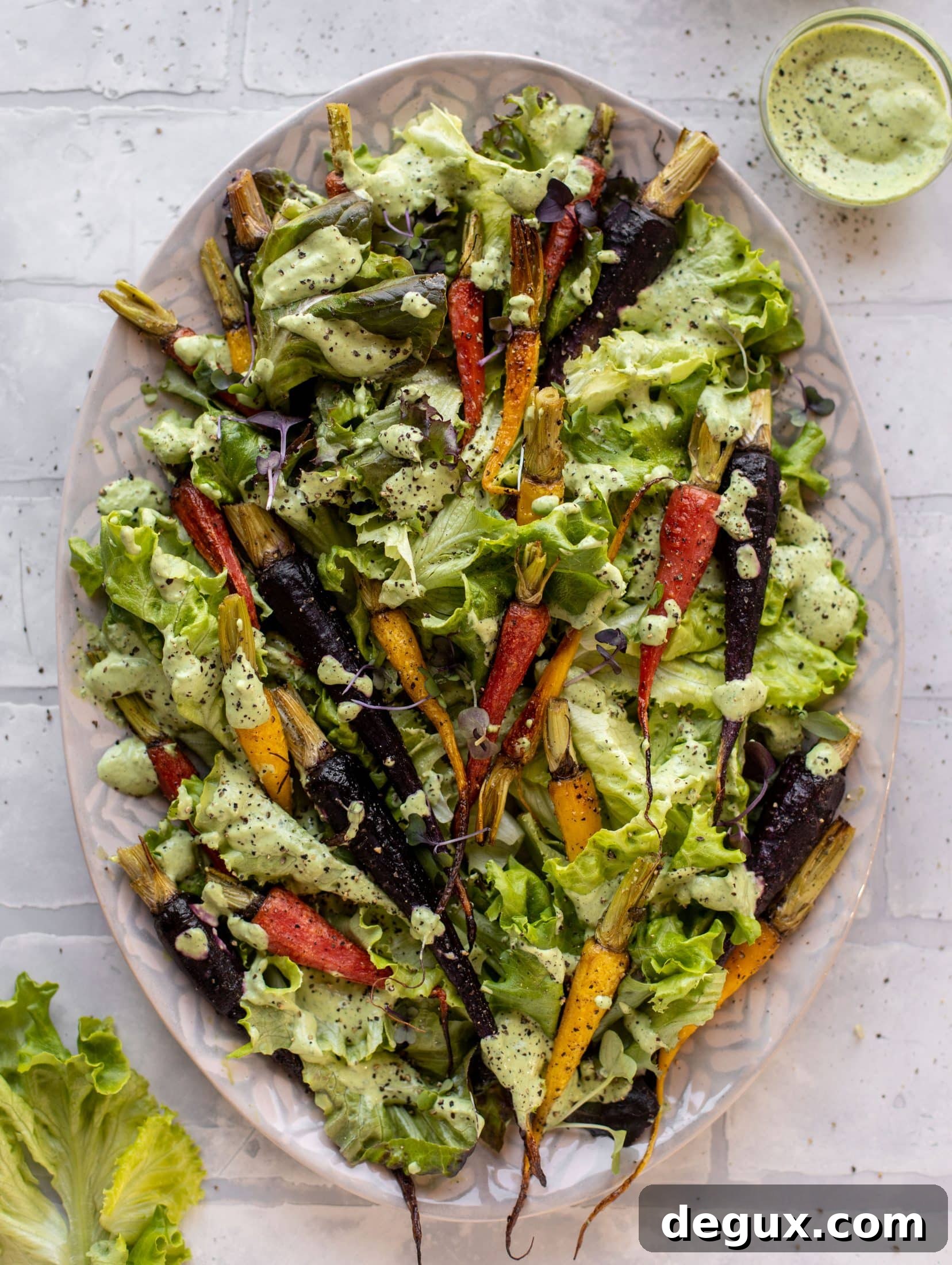 This roasted carrot salad is perfect for spring! Caramely, roasted carrots served over butter greens dressing with green goddess. Simple but delish.