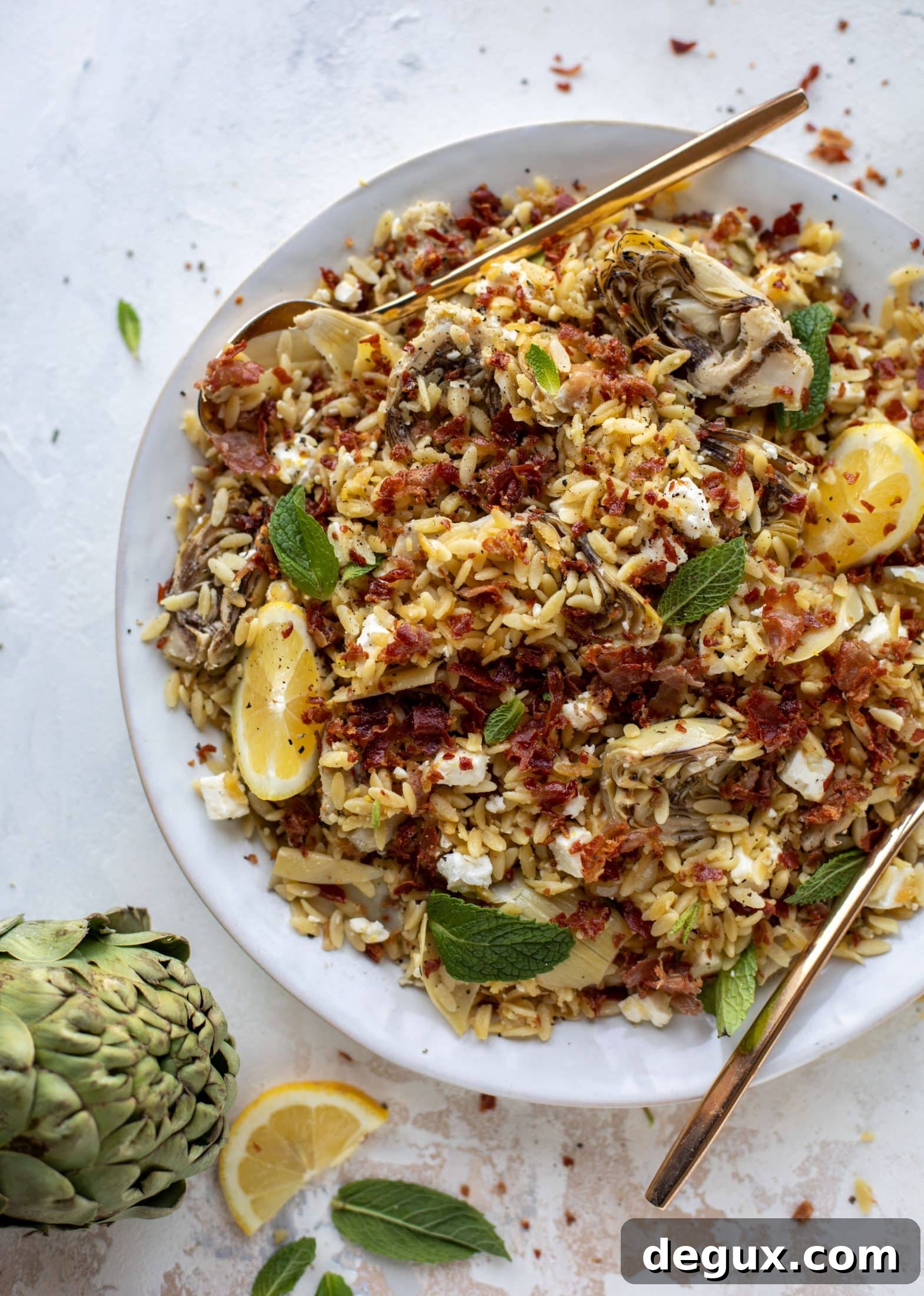 This crispy orzo is a wonderful spring dish. Artichoke hearts, lemon, goat cheese and herbs all topped with a sprinkling of crunchy prosciutto. 