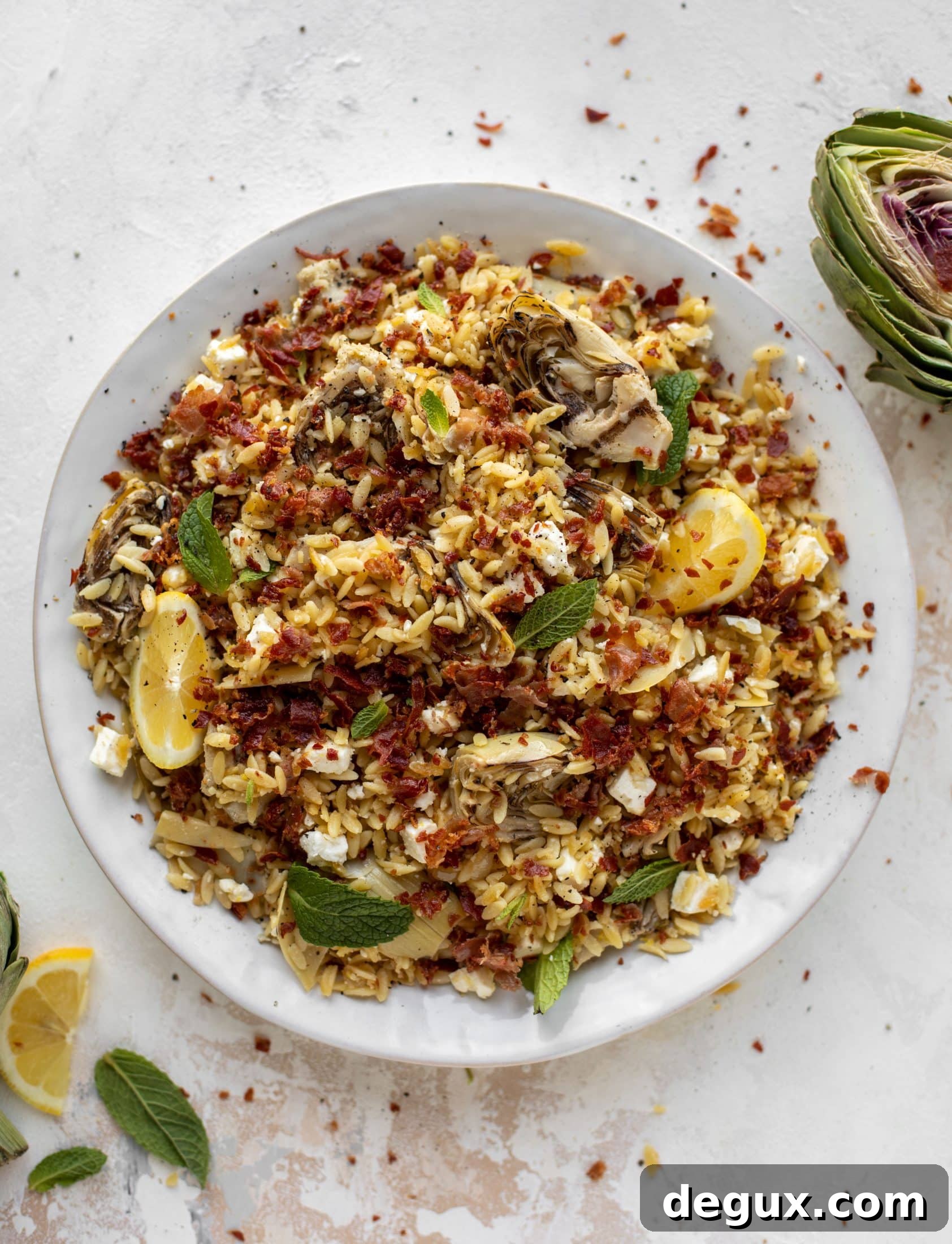 This crispy orzo is a wonderful spring dish. Artichoke hearts, lemon, goat cheese and herbs all topped with a sprinkling of crunchy prosciutto. 
