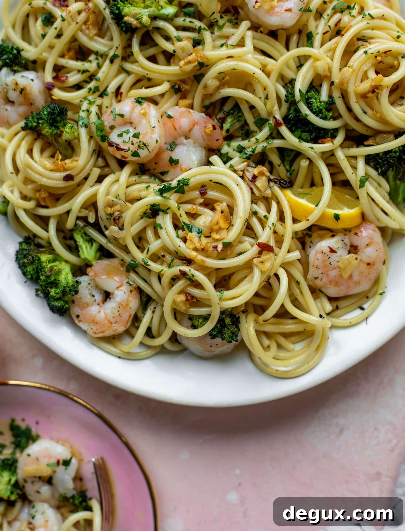 This garlic sauce pasta is incredible! Roasted shrimp and broccoli twirled with garlic oil noodles and crushed red pepper. Divine!