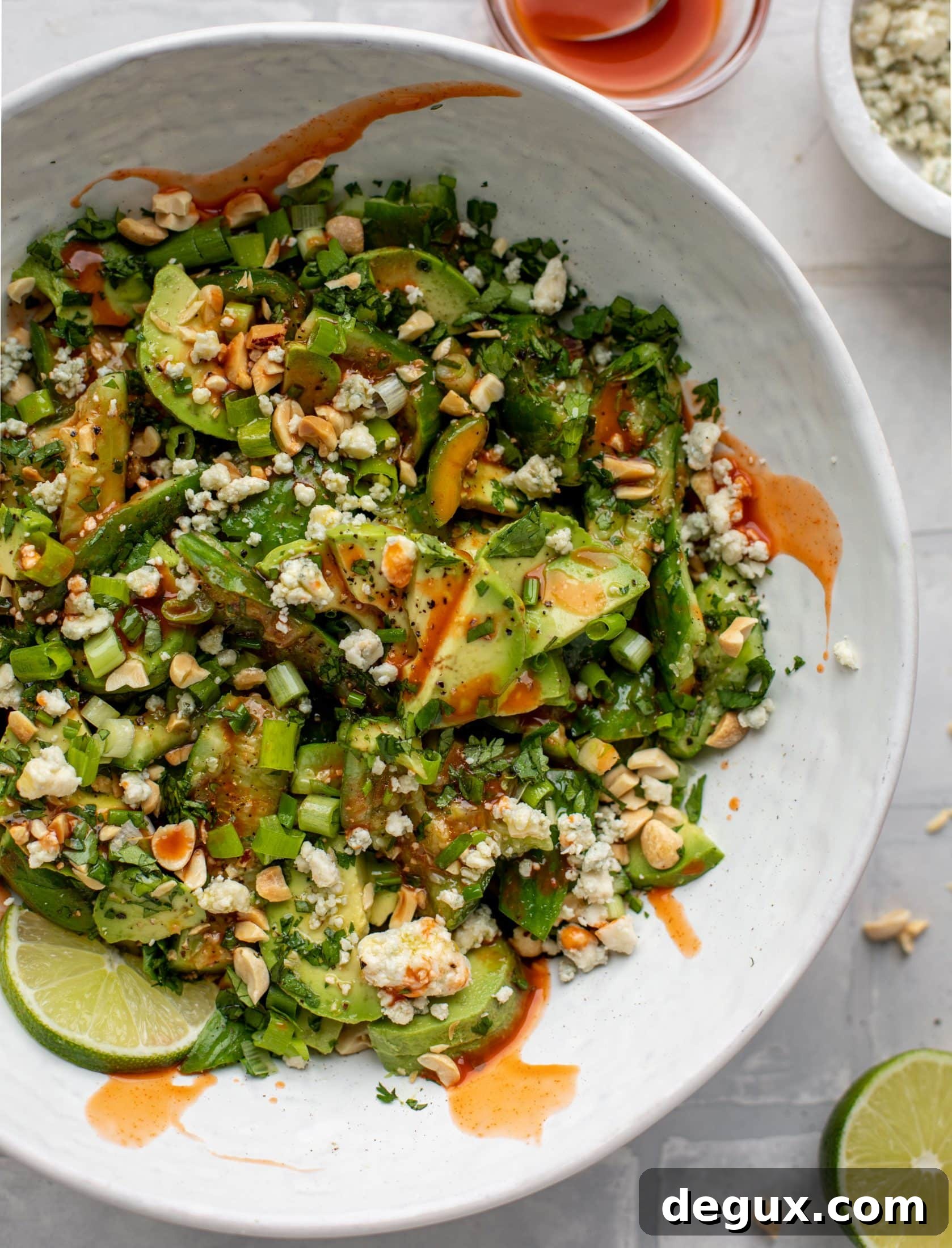 This smashed buffalo cucumber salad is filled with tons of buffalo wing flavor! Avocado, blue cheese, peanuts and lime juice make this irresistible. 