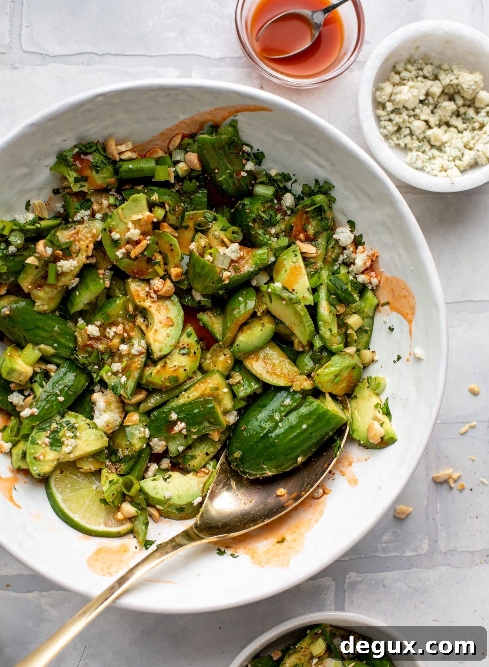 This smashed buffalo cucumber salad is filled with tons of buffalo wing flavor! Avocado, blue cheese, peanuts and lime juice make this irresistible. 