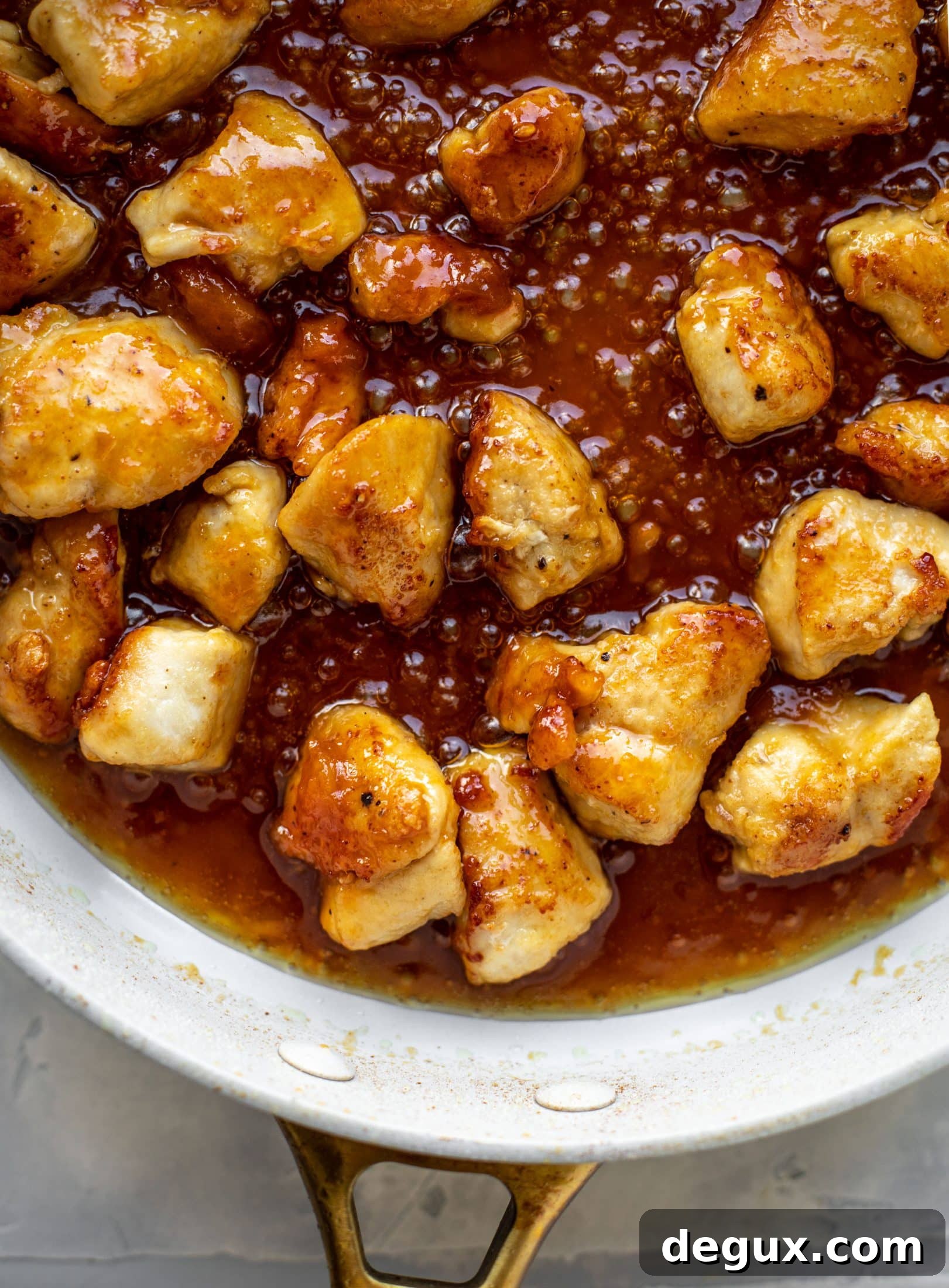 This sticky apricot chicken is so juicy and delicious! The chicken is seared and glazed with a jammy apricot sauce. Serve with broccoli and rice!
