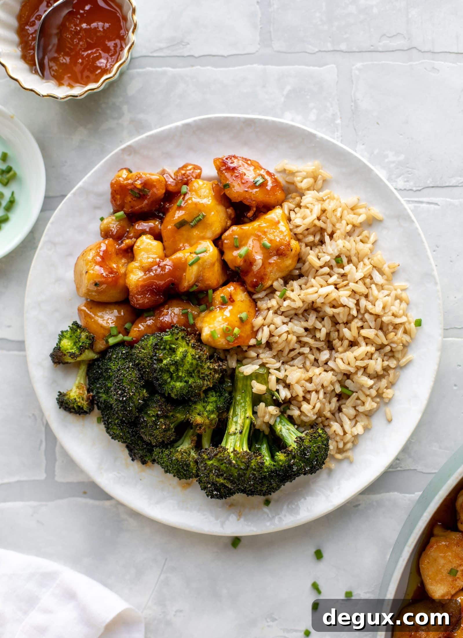 This sticky apricot chicken is so juicy and delicious! The chicken is seared and glazed with a jammy apricot sauce. Serve with broccoli and rice!