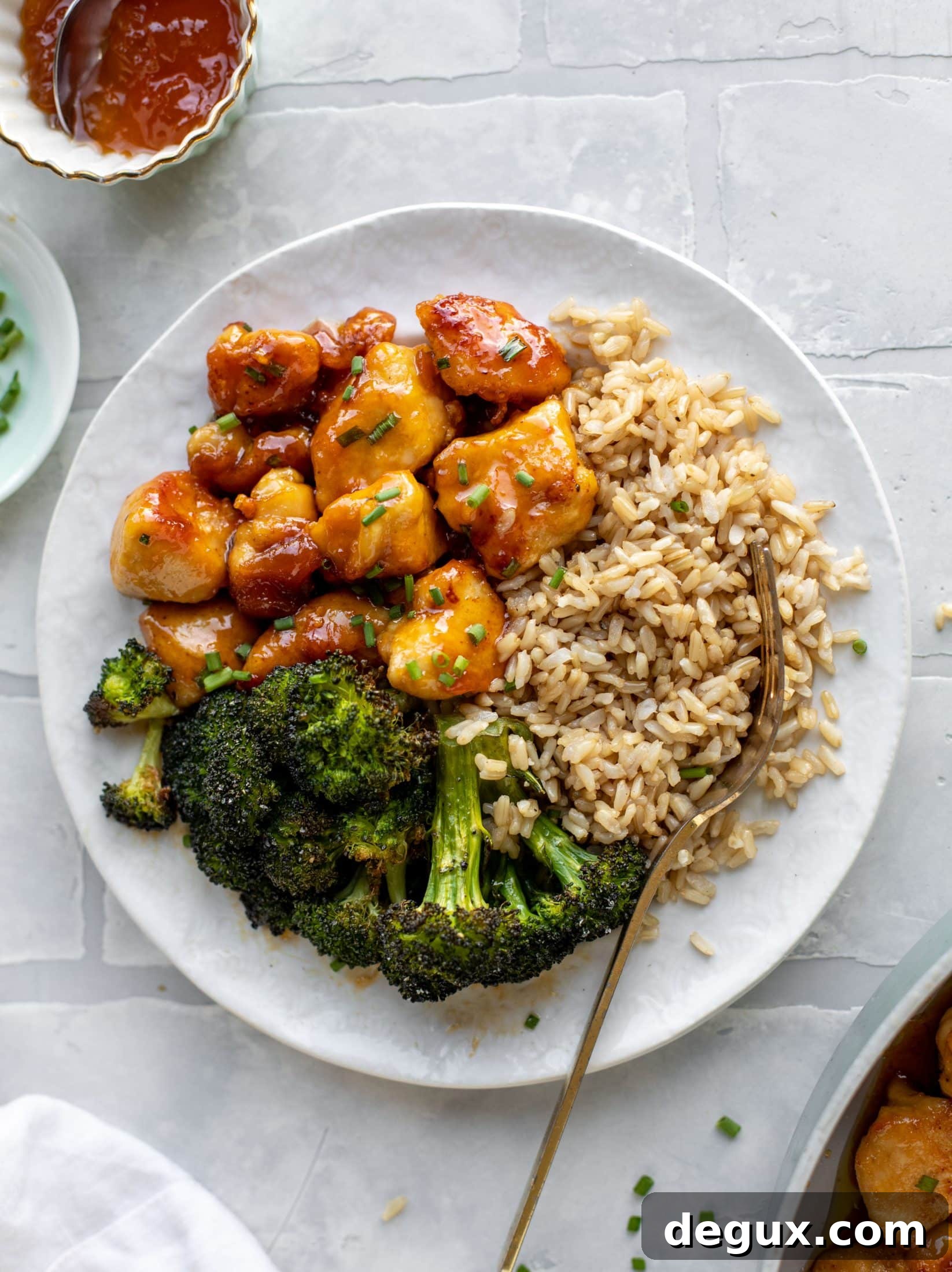 This sticky apricot chicken is so juicy and delicious! The chicken is seared and glazed with a jammy apricot sauce. Serve with broccoli and rice!