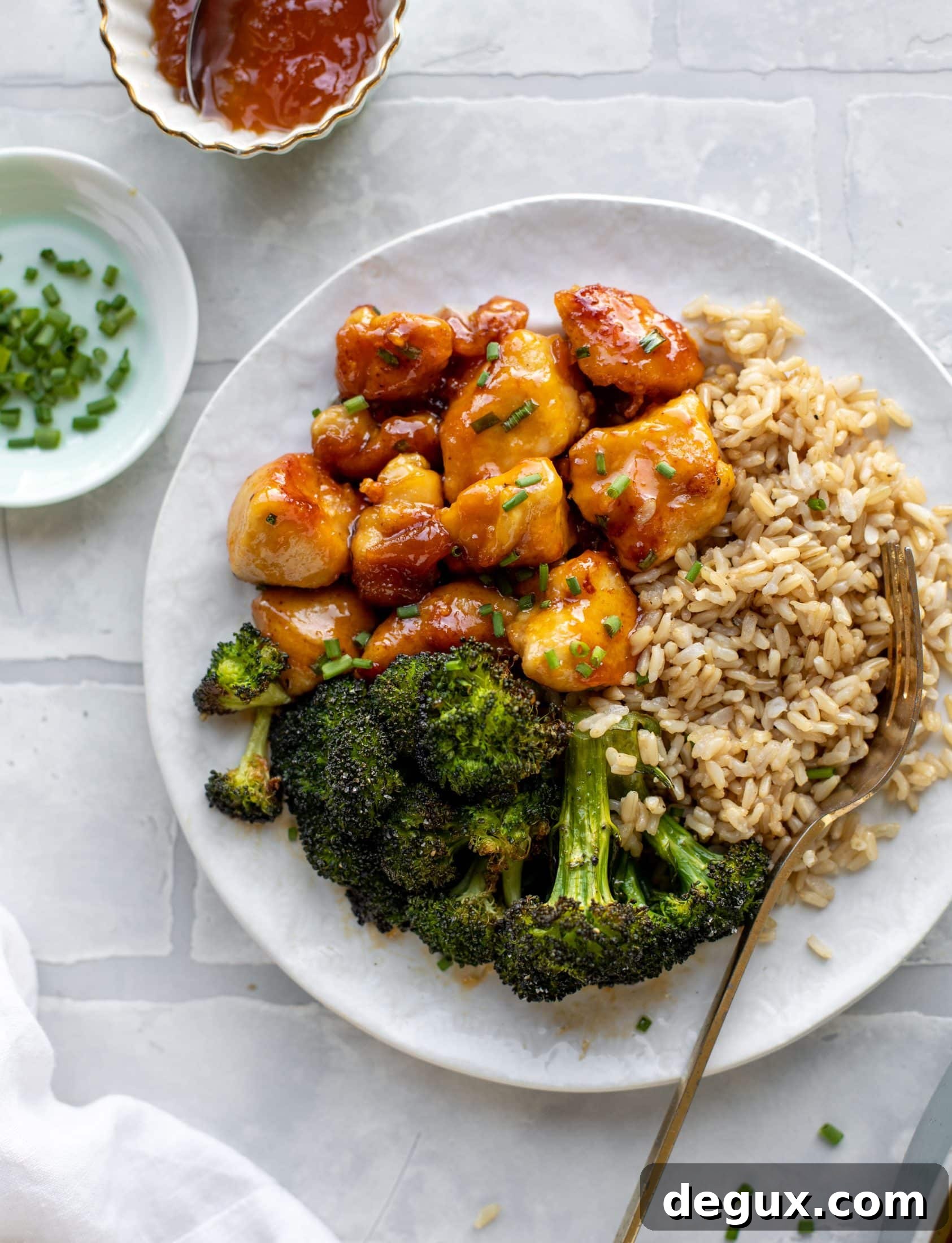 This sticky apricot chicken is so juicy and delicious! The chicken is seared and glazed with a jammy apricot sauce. Serve with broccoli and rice!