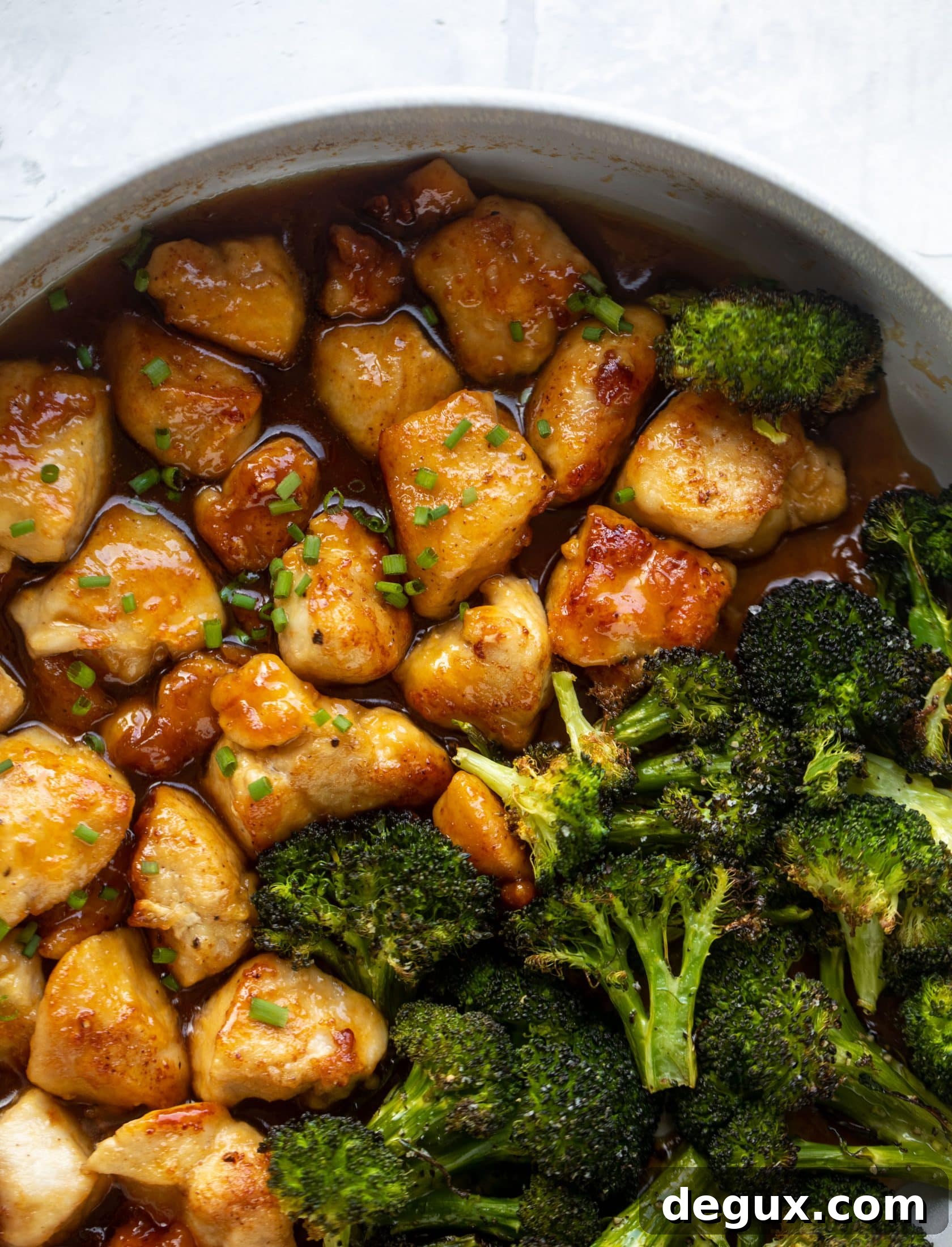 This sticky apricot chicken is so juicy and delicious! The chicken is seared and glazed with a jammy apricot sauce. Serve with broccoli and rice!