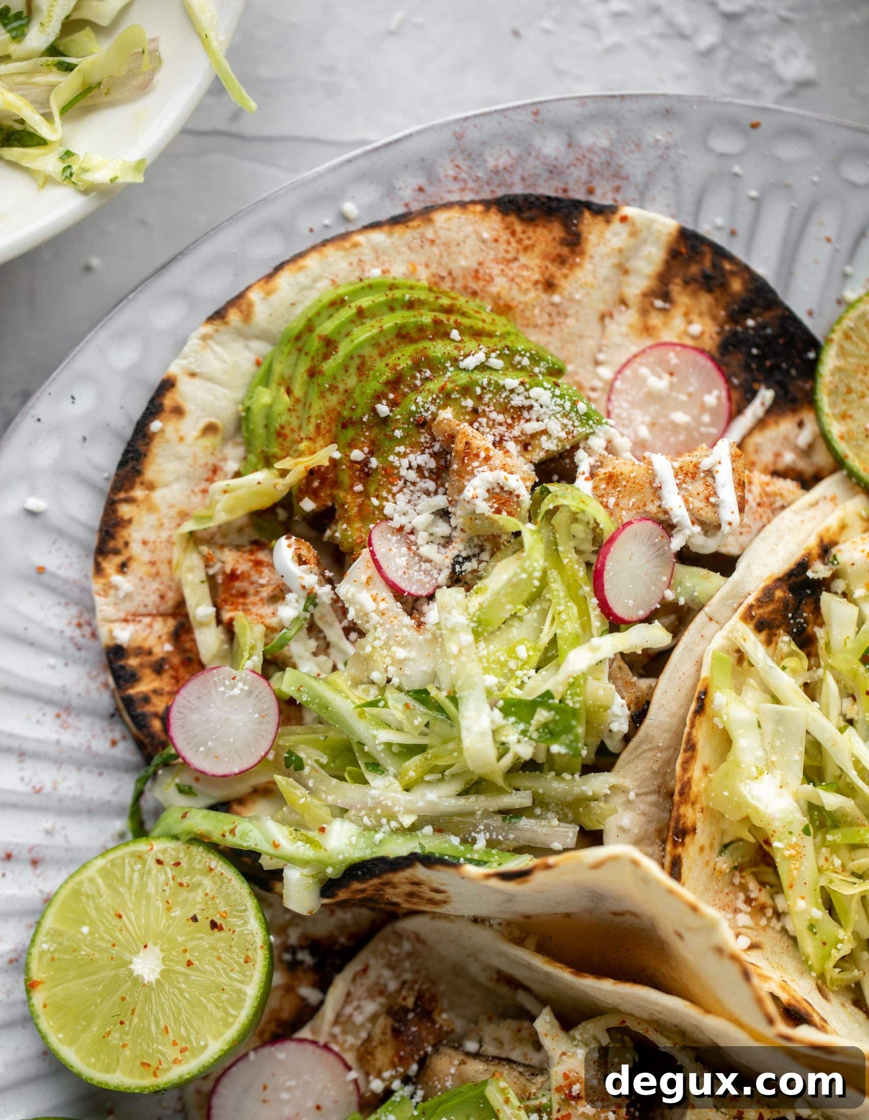 These grilled chicken tacos are easy and flavorful. They are super smoky, then topped with a key lime slaw that is absolutely delicious!